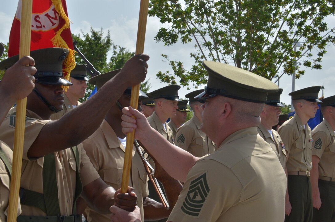 Master Gunnery Sgt. John Trotta, operations chief and acting sergeant major for U.S. Marine Corps Forces South, retrieves the unit battle colors from Sgt. Jamie Brown.  Brig. Gen. W. Blake Crowe relinquished command of U.S. Marine Corps Forces South to Brig. Gen. David Coffman during a change of command ceremony at the U.S. Southern Command headquarters June 21.  (U.S. Army photo by Juan Chiari/Released)
