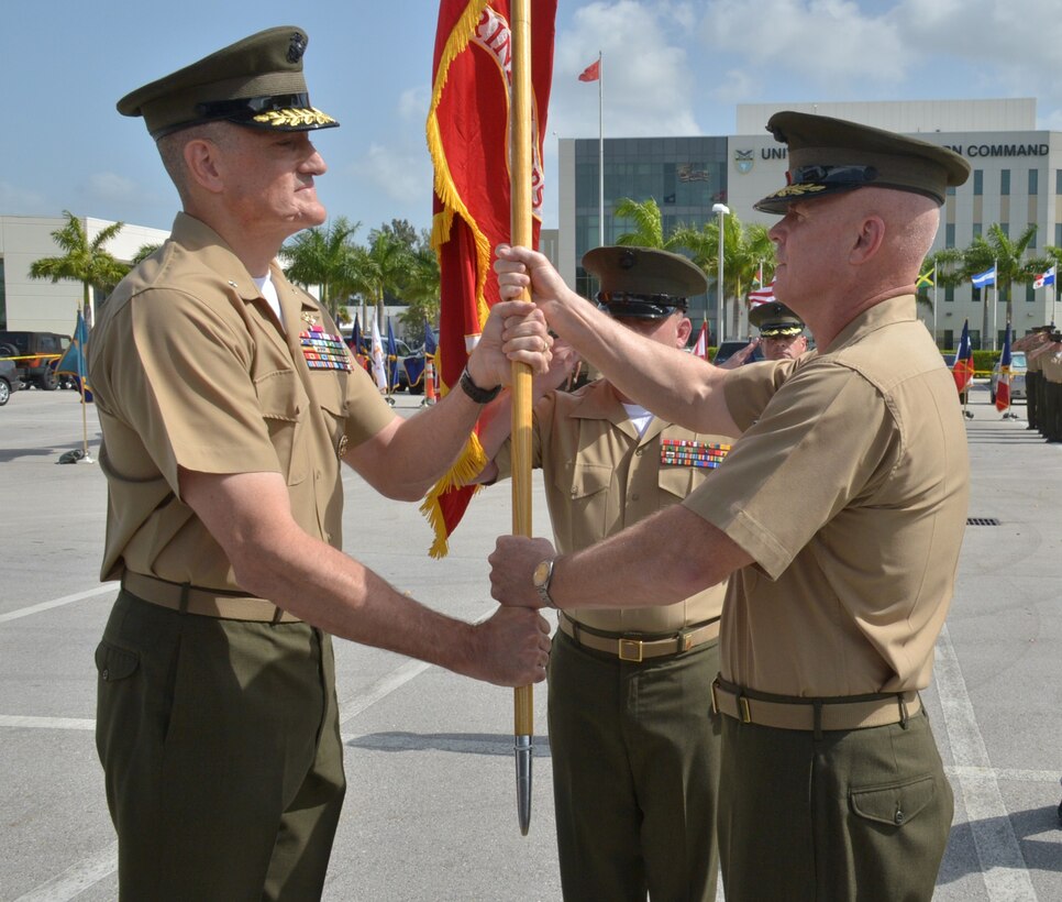 U.S. Marine Corps Brig. Gen. W. Black Crowe passes U.S. Marine Corps Forces South battle colors to Brig. Gen. David Coffman, signifying the official passage of command during a change of command ceremony here, June 21.  Crowe relinquished command of U.S. Marine Corps Forces South to Coffman during a change of command ceremony at the U.S. Southern Command headquarters.  (U.S. Army photo by Juan Chiari/Released)