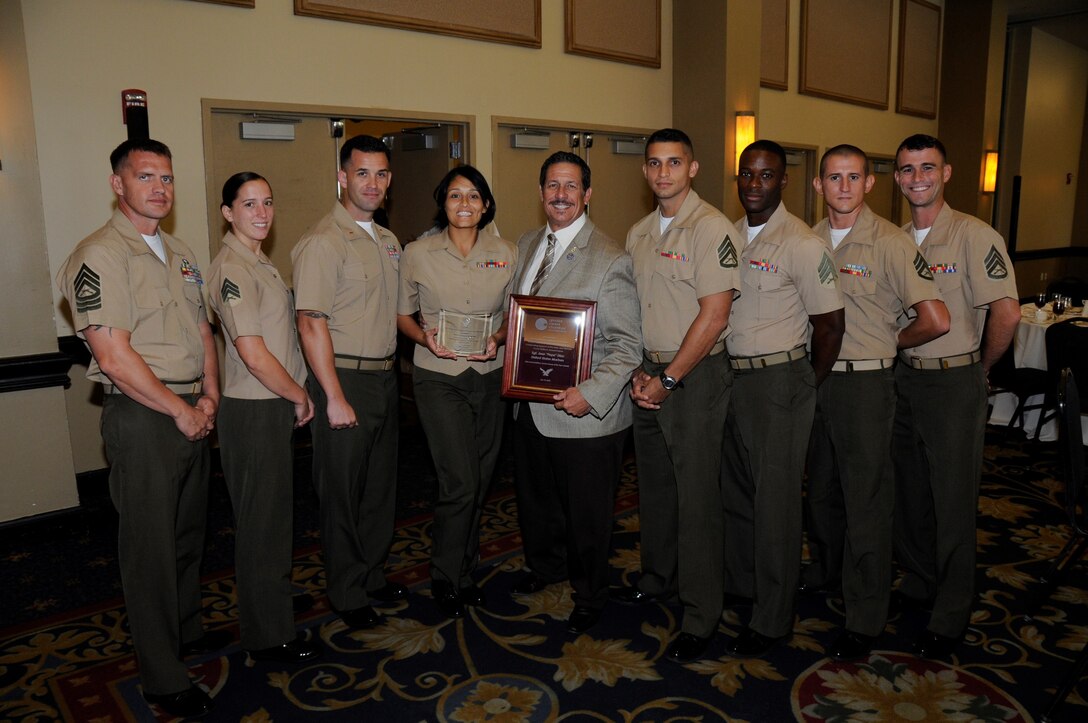 Sergeant Aisha S. Shapiro Kinghorn, an administrative clerk with U.S. Marine Corps Forces South, poses for a photo with her fellow Marines and Jose “Pepe” Diaz, commissioner of Miami-Dade County District 12, after receiving an award for her volunteer service to the greater Miami community. The Chamber’s board of trustees selected service members for the award based on their individual accomplishments and volunteer service to the Miami community. (Official U.S. Marine Corps photo by courtesy/Released)