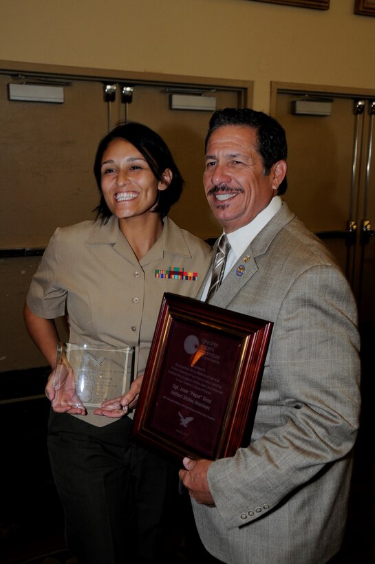 Sergeant Aisha S. Shapiro Kinghorn, an administrative clerk with U.S. Marine Corps Forces South, poses for a photo with Jose “Pepe” Diaz, commissioner of Miami-Dade County District 12, after receiving an award for her volunteer service to the greater Miami community. The Chamber’s board of trustees selected service members for the award based off of their individual accomplishments and volunteer service to the Miami community. (Official U.S. Marine Corps photo by SSgt. Earnest J. Barnes/Released)