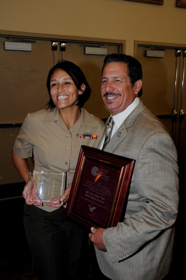 Sergeant Aisha S. Shapiro Kinghorn, an administrative clerk with U.S. Marine Corps Forces South, poses for a photo with Jose “Pepe” Diaz, commissioner of Miami-Dade County District 12, after receiving an award for her volunteer service to the greater Miami community. The Chamber’s board of trustees selected service members for the award based off of their individual accomplishments and volunteer service to the Miami community. (Official U.S. Marine Corps photo by SSgt. Earnest J. Barnes/Released)