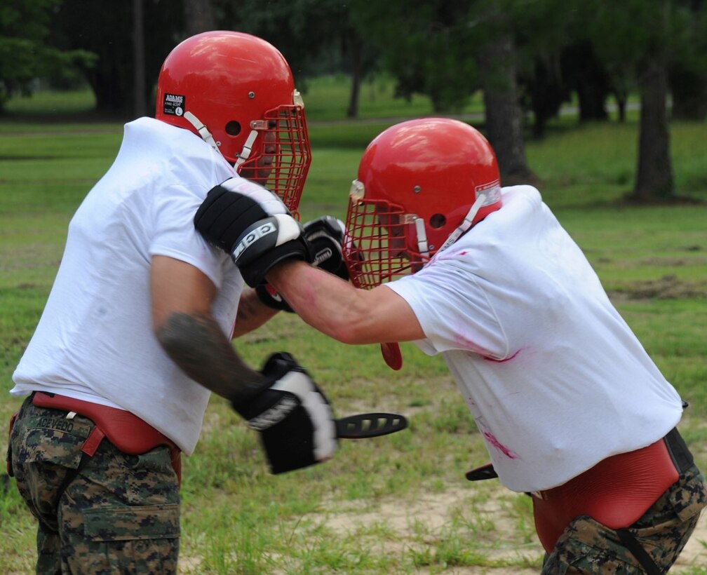 Marines practice knife fighting skills during Marine Corps Martial Arts Program training July 12 near the MCMAP dojo.  Marines wore white shirts that showed red lipstick marks, which simulated blood, from their opponents’ knife strikes. Some of the knife techniques the students practiced during the knife fighting skills were forward thrust, reverse thrust, forward and reverse slashes, straight thrusts, and the idea was to focus on killing blows and vital shots to the carotid artery and major organs.