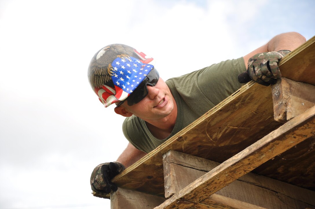 U.S. Marine Corps Sgt. Maximilian Beres, a combat engineer from Marine Wing Support Squadron 472, installs roof decking to repair the Hattieville Government Pre-School, June 4, as part of exercise New Horizons.  Engineers from both the U.S. and Belize are constructing various structures at schools throughout Belize as part of the exercise. (U.S. Air Force photo by Capt. Holly Hess/Released)