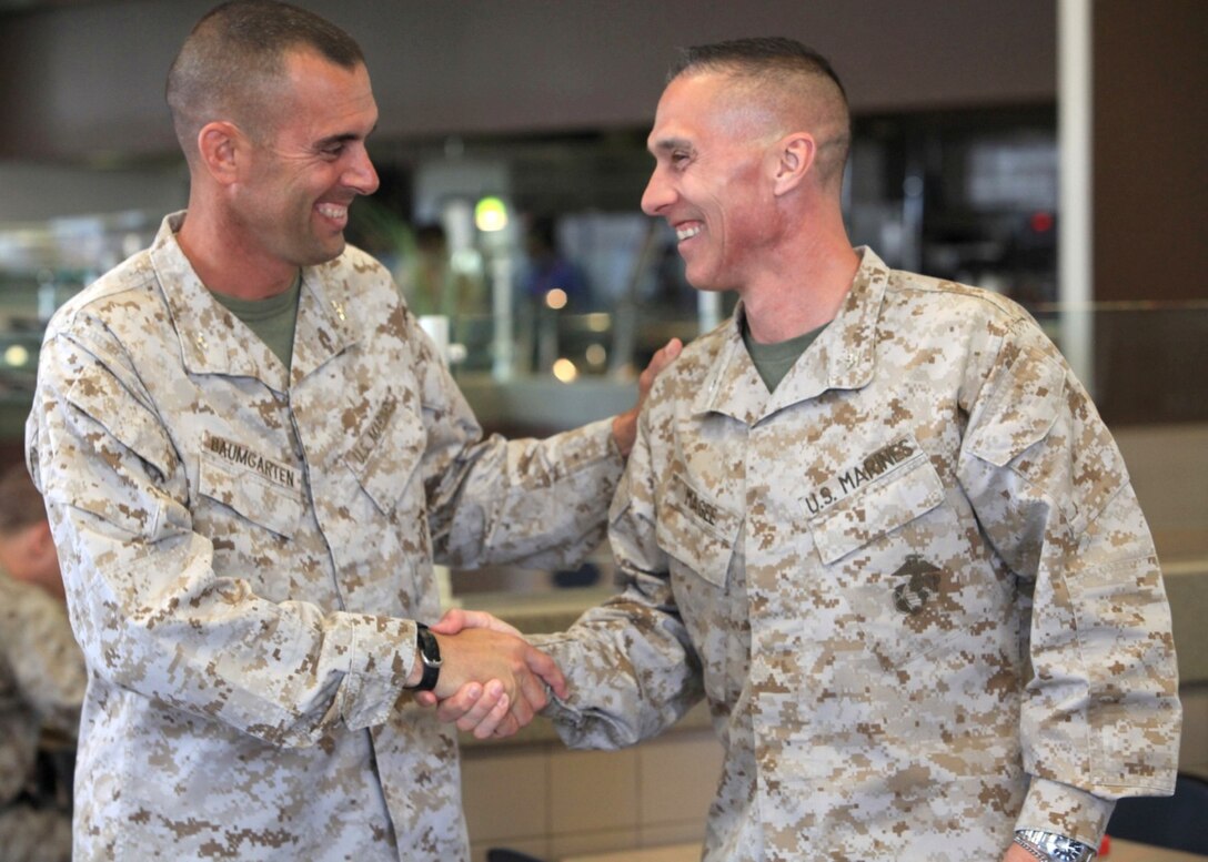 Col. Pete Baumgarten, the commanding officer of 1st Marine Regiment, greets Col. Sean Magee, the deputy chief of staff plans for Joint Enabling Capabilities Command, during training for Southeast County Young Marines at Camp Pendleton, Calif., July 19. The two colonels served together during the Gulf War. The program brought them together after twenty-three years.