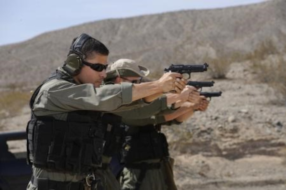 Members of MCLB Barstow’s Special Reaction Team fire their pistols on the base range July 16. During the exercise, members of the Marine Corps Police Department were able to keep their marksmanship skills up to par.



