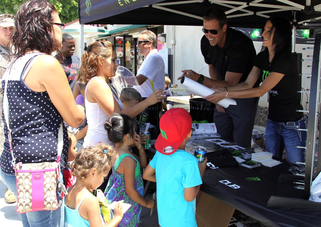 Guests win Monster mechandise after spinning the wheel at the Monster DUB event held at the Country Store here July 25. The event included free food, Monster samples, Monster merchandise and a display of Monster DUB cars. "We are holding this event to increase awareness of the mainside complex; the main store, the Country Store and the Vineyard to let people know that we are still here for our customers and supporting them," said Jill Calderon, the main side complex manager. "This event is also a way to give back to our military for all the hard work they do."