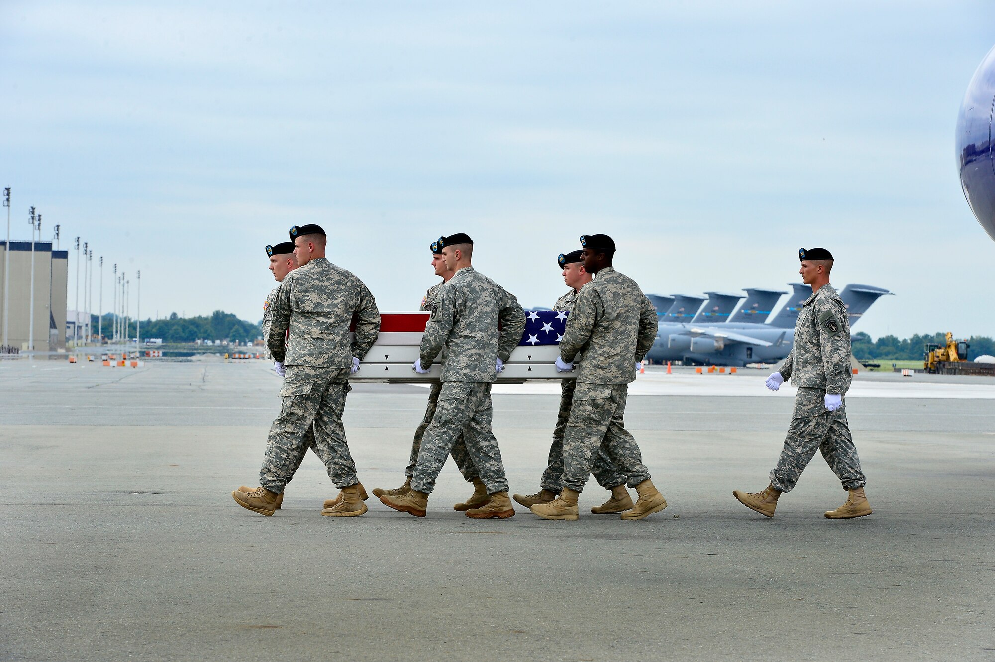 A U.S. Army carry team transfers the remains of Army Sgt. Stefan M. Smith, of Glennville, Ga., at Dover Air Force Base, Del., July 25, 2013. Smith was assigned to the 3rd Battalion, 15th Infantry Regiment, 4th Infantry Brigade Combat Team, 3rd Infantry Division, Fort Stewart, Ga. (U.S. Air Force photo/David Tucker)
