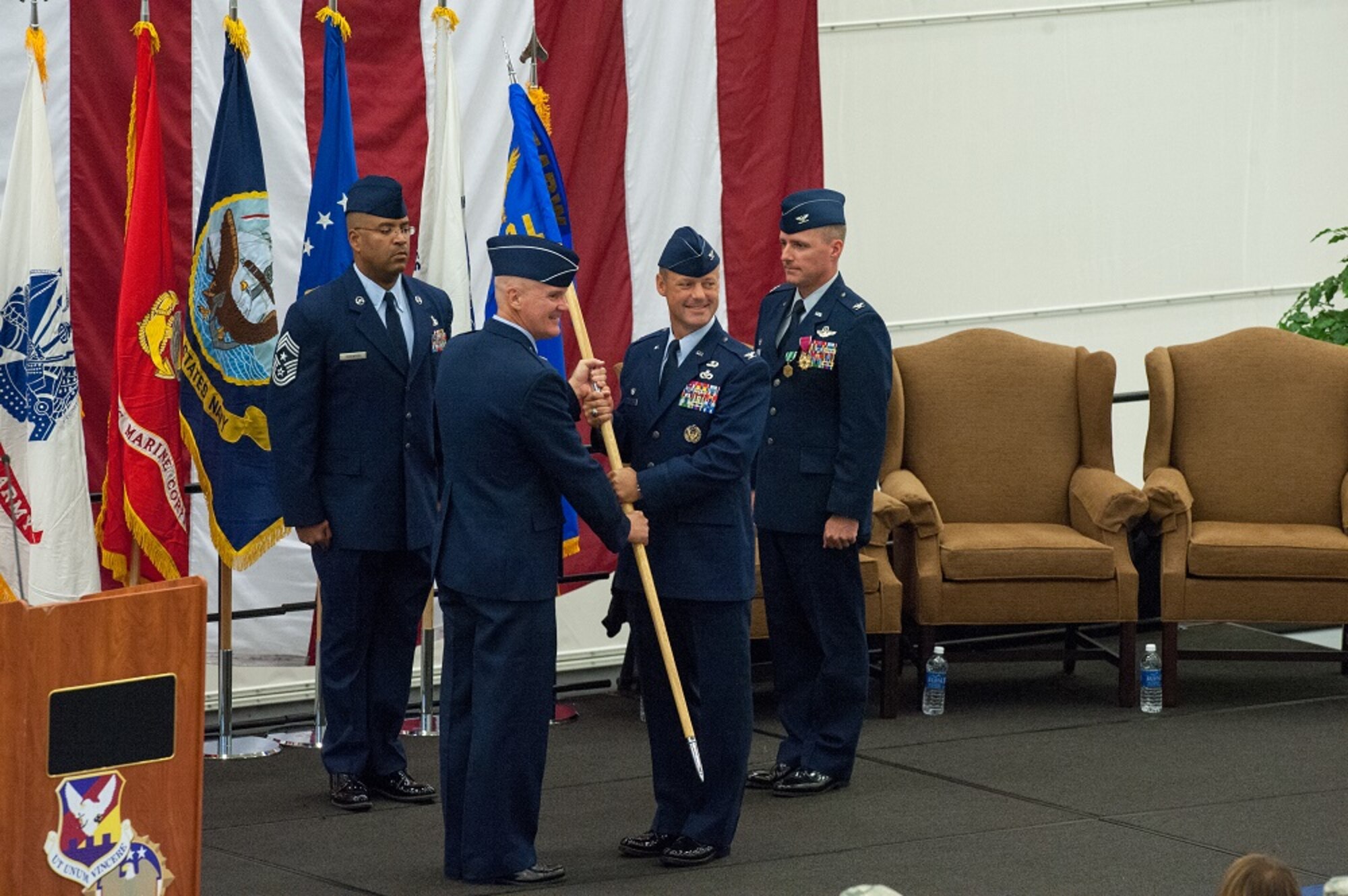 Brig. Gen. Randall C. Guthrie, U.S. Air Force Expeditionary Center commander, passes the guidon to Col. James C. Hodges, who assumed command of Joint Base McGuire-Dix-Lakehurst and the 87th Air Base Wing July 25, 2013, in the VR-64 Hangar at the joint base.  (U.S. Air Force photo by Wayne Russell/Released)