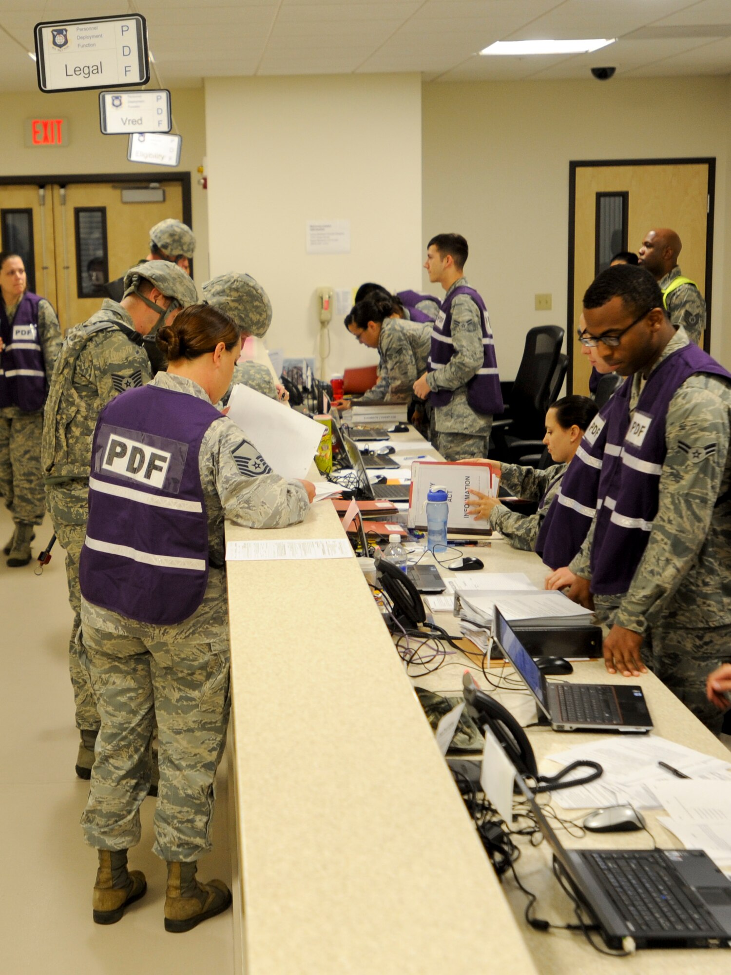 VANDENBERG AIR FORCE BASE, Calif. – Team V members process through the Personnel Deployment Function line during an exercise here Thursday, July 25, 2013. The PDF line was held as part of a Consolidated Unit Inspection, a biannual inspection used to measure the base’s discipline, readiness and war fighting capability through exercises, inspection and evaluations. (U.S. Air Force photo/Airman Yvonne Morales)