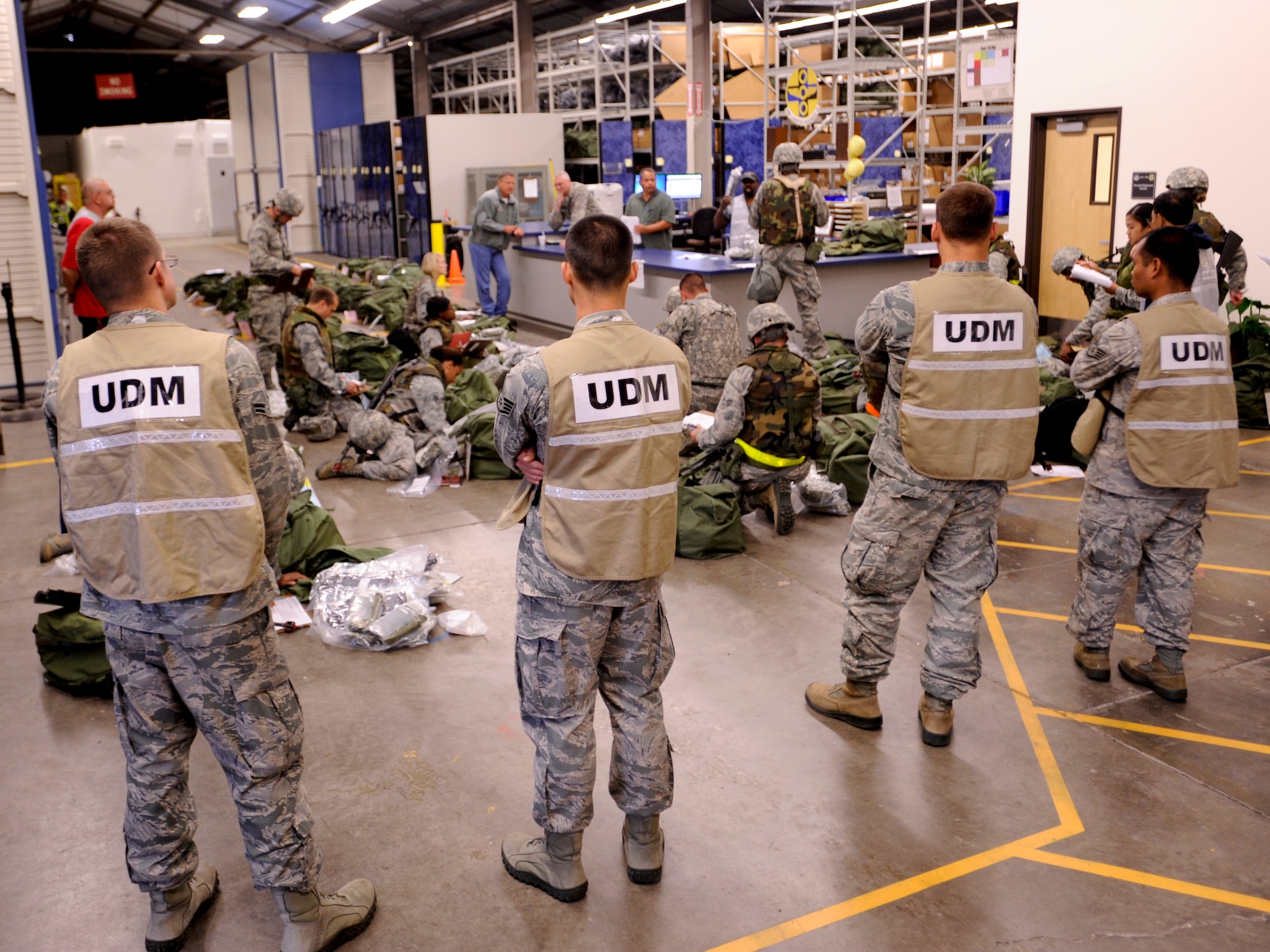 VANDENBERG AIR FORCE BASE, Calif. – Unit Deployment Managers stand by to assist the deploying Airmen during an exercise here Thursday, July 25, 2013. The exercise was held as part of a Consolidated Unit Inspection, a biannual inspection used to measure the base’s discipline, readiness and war fighting capability through exercises, inspection and evaluations. (U.S. Air Force photo/Airman Yvonne Morales)