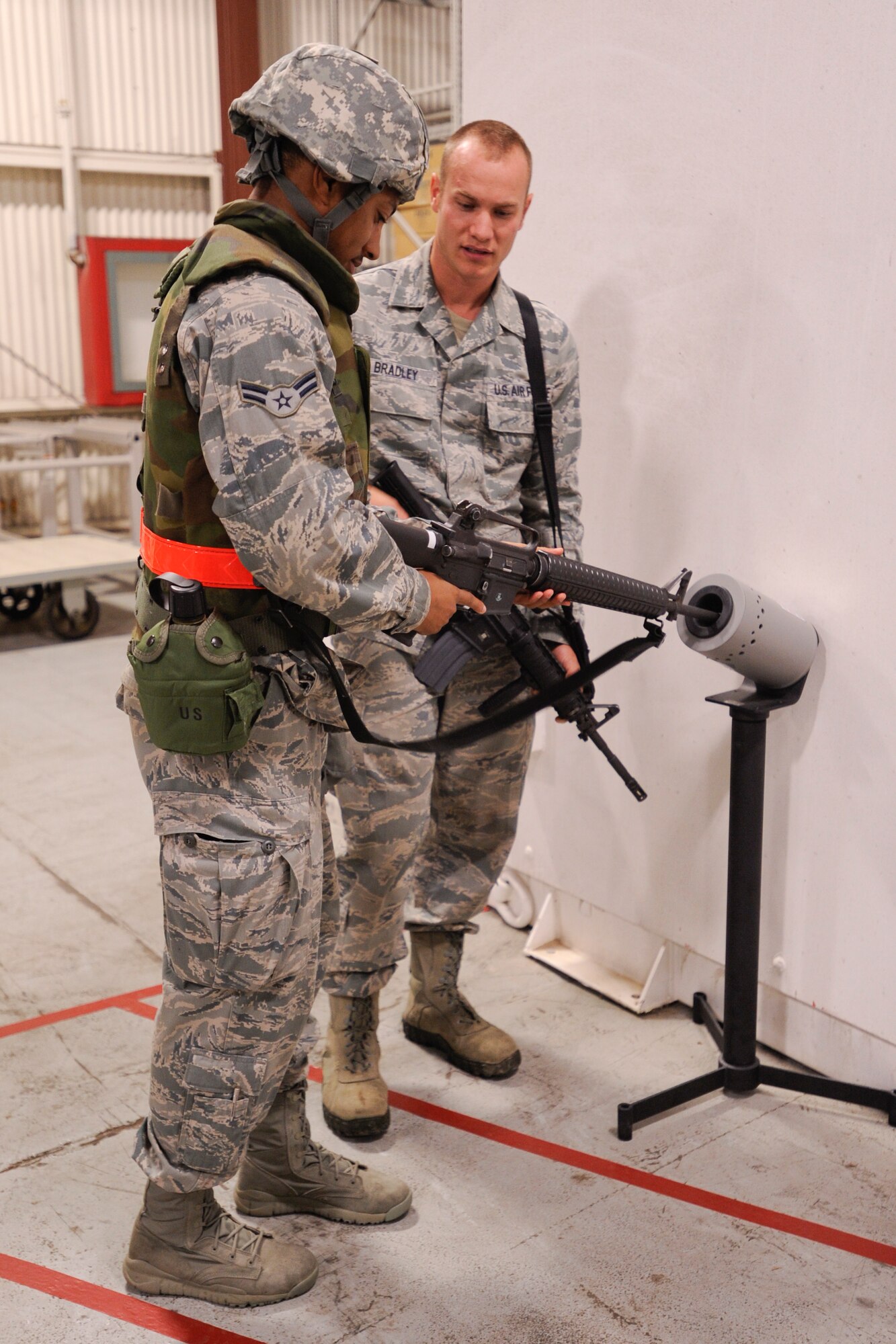 VANDENBERG AIR FORCE BASE, Calif. – Airman 1st Class Branson McKinney, 30th Space Communication Squadron knowledge operation apprentice, clears his weapon during an exercise here Thursday, July 25, 2013. The exercise was held as part of a Consolidated Unit Inspection, a biannual inspection used to measure the base’s discipline, readiness and war fighting capability through exercises, inspection and evaluations. (U.S. Air Force photo/Airman Yvonne Morales)