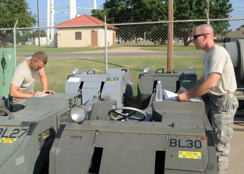 Airman 1st Class Justin Rushing and Senior Airman William Moore, both from the 2nd Logistics Readiness Squadron shipment distribution center, inventory cargo on Barksdale Air Force Base, La., July 25, 2013. The shipment distribution center is the single point of entry for transport within the Defense Transportation System. (U.S. Air Force photo/Senior Airman Sean Martin)
