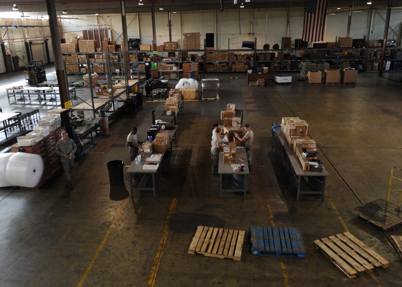 Airmen from the 2nd Logistics Readiness Squadron shipment distribution center package cargo on Barksdale Air Force Base, La., July 25, 2013. The shipment distribution center handles more than 10 shipments of cargo per week that come through the base. (U.S. Air Force photo/Senior Airman Sean Martin)