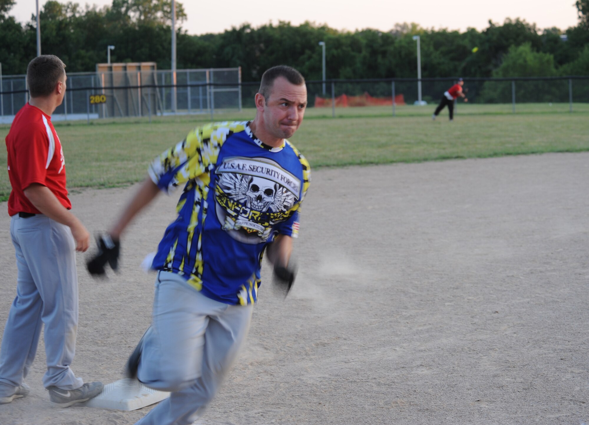 Jesus Guerra, Security Forces-A team member, rounds third base before scoring a run against the Civil Engineering team at Whiteman Air Force Base, Mo., July 22, 2013. SF-A hit one home run in the loss but was overpowered by CE which hit two home runs. (U.S. Air Force photo by Airman 1st Class Bryan Crane/Released)