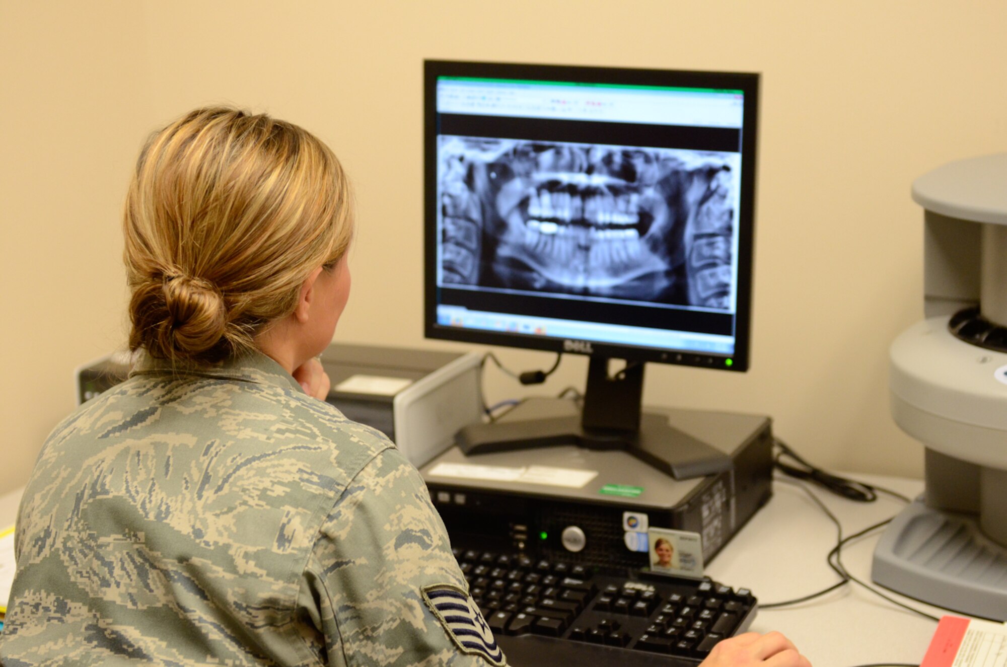 U.S. Air Force Tech. Sgt. Carly Edwards, a dental technician with the 139th Medical Group, Missouri Air National Guard, reviews dental images at Rosecrans Air National Guard Base, Mo., July 24, 2013.  The Medical Group restored function to the x-ray machine this Spring after it being non-functional for more than two years. (U.S. Air National Guard photo by Tech. Sgt. Theo Ramsey/Released)