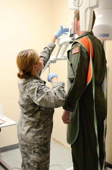 U.S. Air Force Tech. Sgt. Carly Edwards, a dental technician with the 139th Medical Group, Missouri Air National Guard, adjusts the digital x-ray machine at Rosecrans Air National Guard Base, Mo., July 24, 2013.  The Medical Group restored function to the x-ray machine this Spring after it being non-functional for more than two years. (U.S. Air National Guard photo by Tech. Sgt. Theo Ramsey/Released)