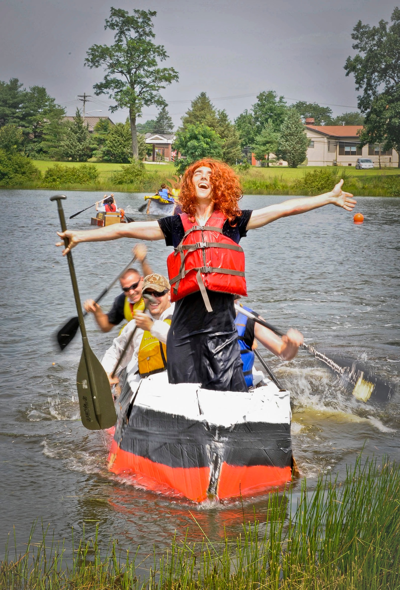 Tech. Sgt. Conor Gray, 373rd Training Squadron KC-10 Extender integrated flight systems instructor, poses like Rose from the film “Titanic” as their cardboard version makes it to the shore during the second annual Cardboard Boat Regatta at Willow Pond July 20, 2013, at Joint Base McGuire-Dix-Lakehurst, N.J. (U.S. Air Force photo by Airman 1st Class Ryan Throneberry/Released)