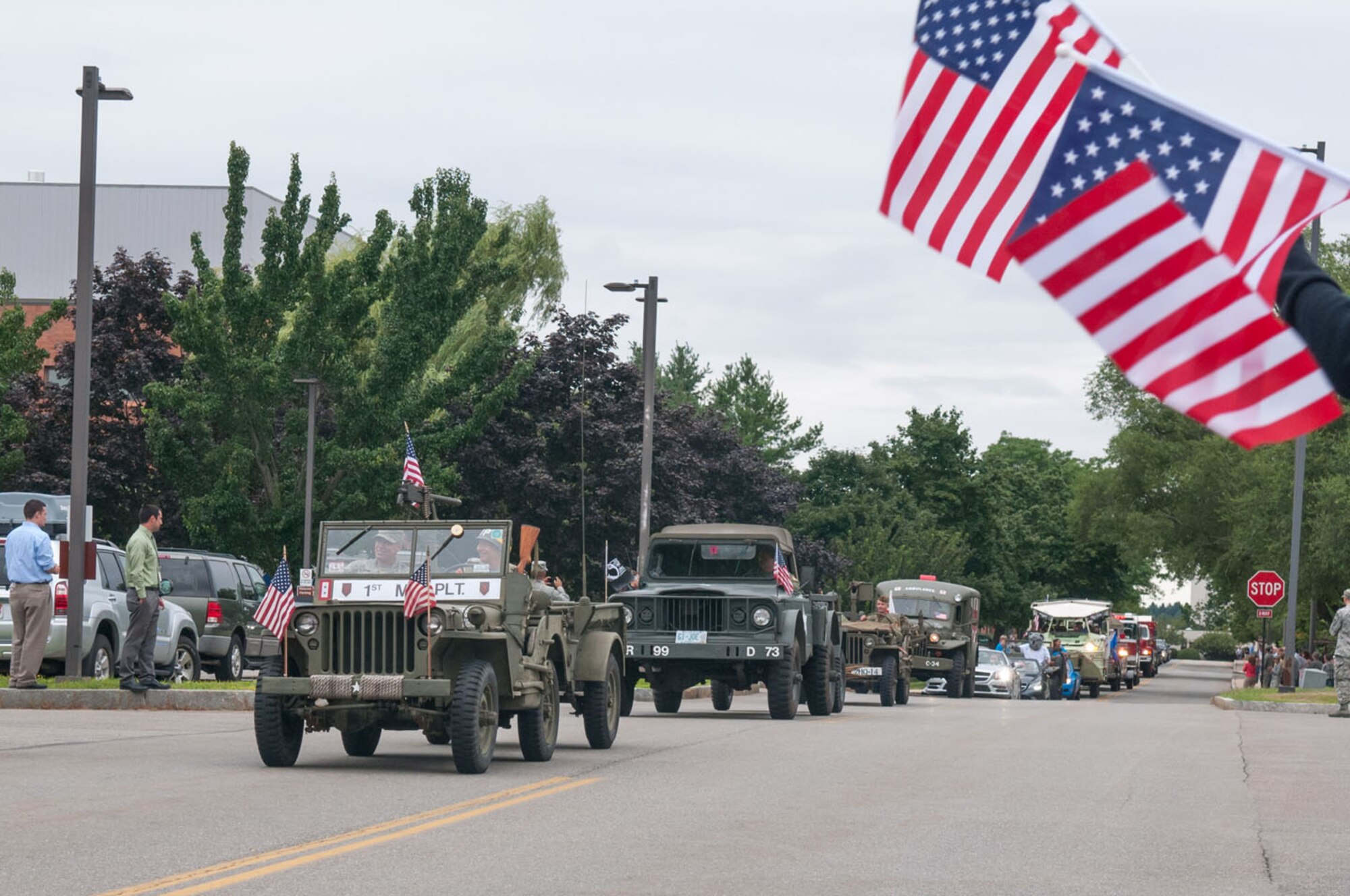 HANSCOM AIR FORCE BASE, Mass. – Base personnel, along with friends and family, lined the streets to wave American flags and show their appreciation to recent deployers during the Hanscom Heroes Homecoming parade July 25. The parade was followed by a picnic in Memorial Park that recognized deployers and their families for outstanding service and commitment. (U.S. Air Force photo by Rick Berry)
