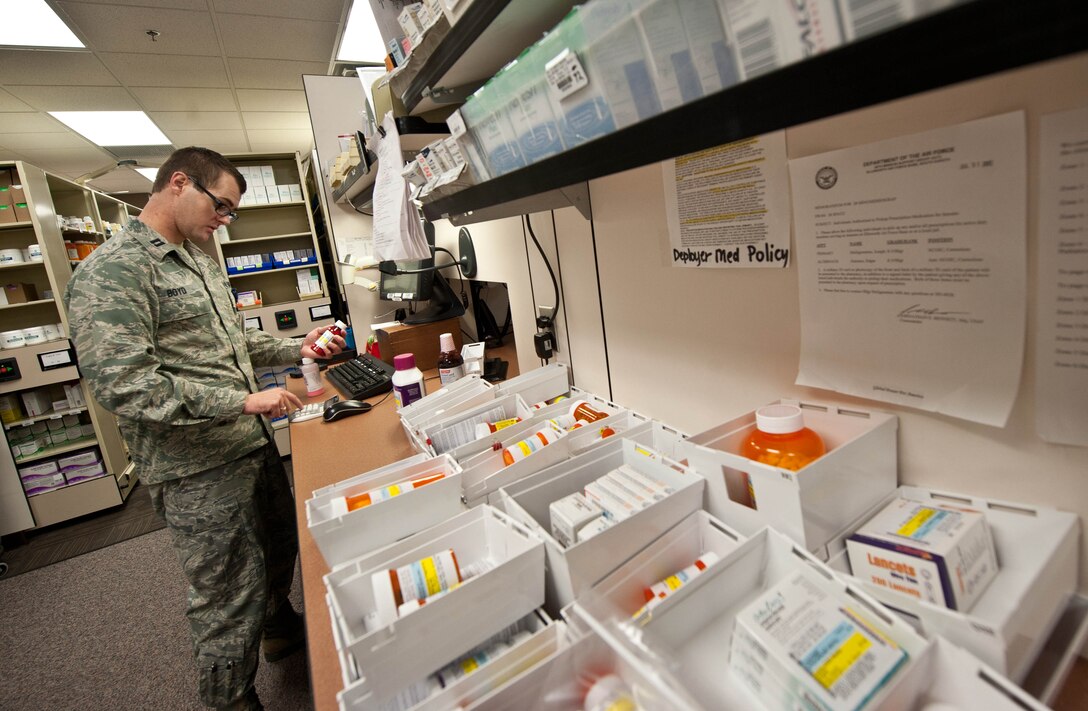 Capt. Richard Boyd, 28th Medical Support Squadron staff pharmacist, processes medication at the pharmacy on Ellsworth Air Force Base, S.D., July 23, 2013. Boyd ensures patient safety by tracking their medications and dosage levels with the Ellsworth pharmacy, which supports 33,000 beneficiaries with 124,000 prescriptions annually. (U.S. Air Force photo by Airman 1st Class Zachary Hada/Released)