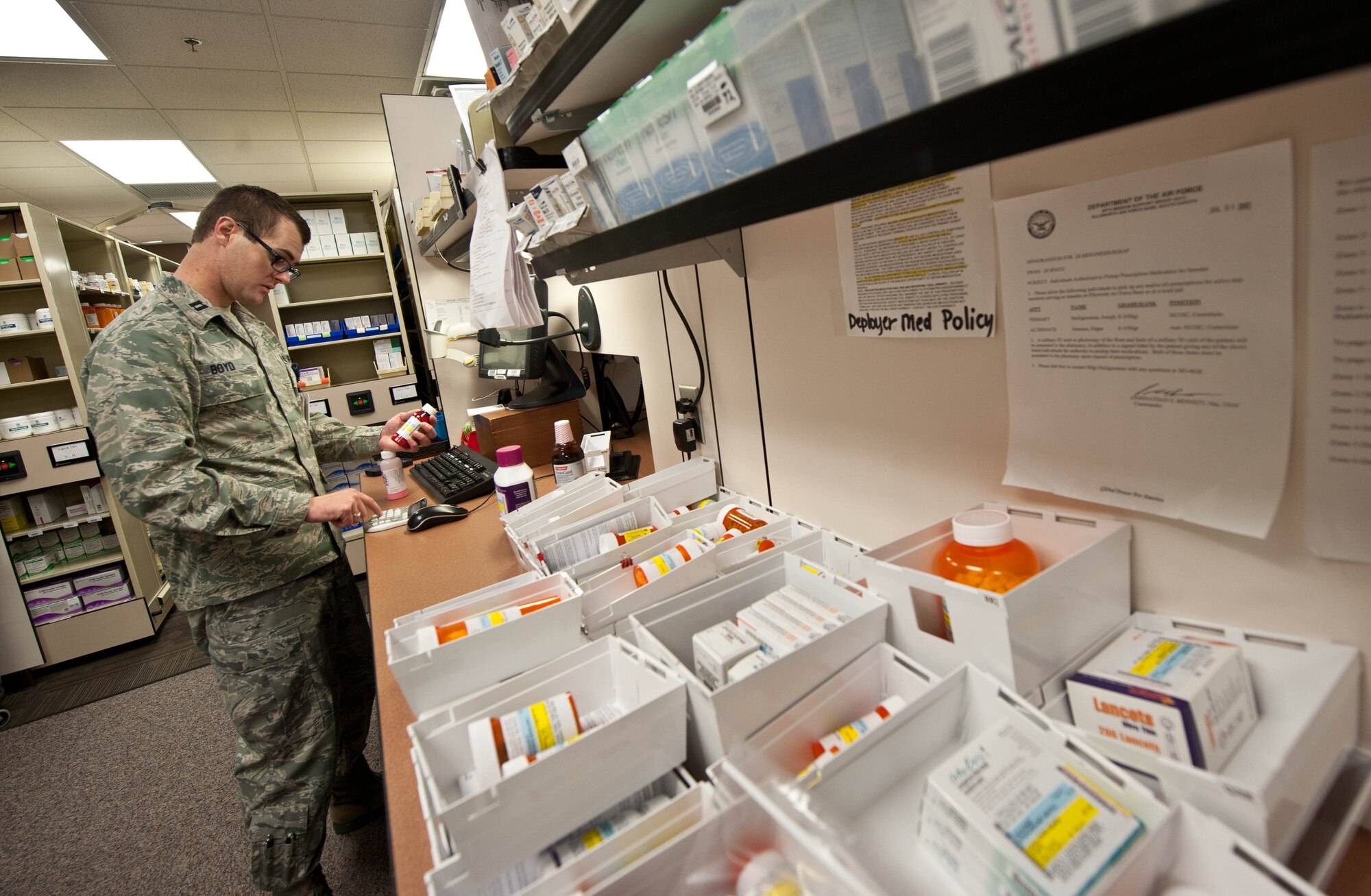 Capt. Richard Boyd, 28th Medical Support Squadron staff pharmacist, processes medication at the pharmacy on Ellsworth Air Force Base, S.D., July 23, 2013. Boyd ensures patient safety by tracking their medications and dosage levels with the Ellsworth pharmacy, which supports 33,000 beneficiaries with 124,000 prescriptions annually. (U.S. Air Force photo by Airman 1st Class Zachary Hada/Released)