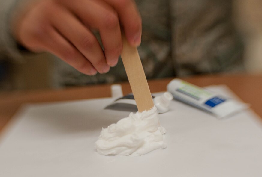Staff Sgt. Ricky Valencia, 28th Medical Support Squadron pharmacy technician, combines hydrocortisone and clotrimazole while filling prescriptions at the pharmacy on Ellsworth Air Force Base, S.D., July 23, 2013. Ellsworth pharmacists play a critical role in preventing medication errors, advise physicians on the best medication choices and work directly with patients to ensure they understand how to properly use their medications safely and effectively. (U.S. Air Force photo by Airman 1st Class Zachary Hada/Released)