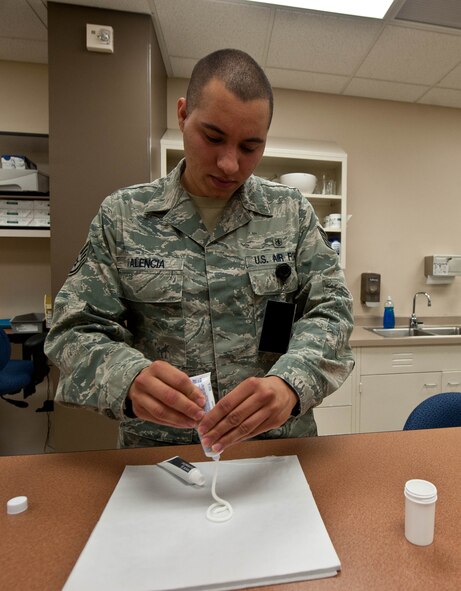 Staff Sgt. Ricky Valencia, 28th Medical Support Squadron pharmacy technician, prepares to mix hydrocortisone and clotrimazole together while filling prescriptions at the pharmacy on Ellsworth Air Force Base, S.D., July 23, 2013. The 28th MDSS pharmacy services are available to active duty members, retirees and family members. Pharmacy members complete an average of 510 prescriptions for Ellsworth customers per day. (U.S. Air Force photo by Airman 1st Class Zachary Hada/Released)