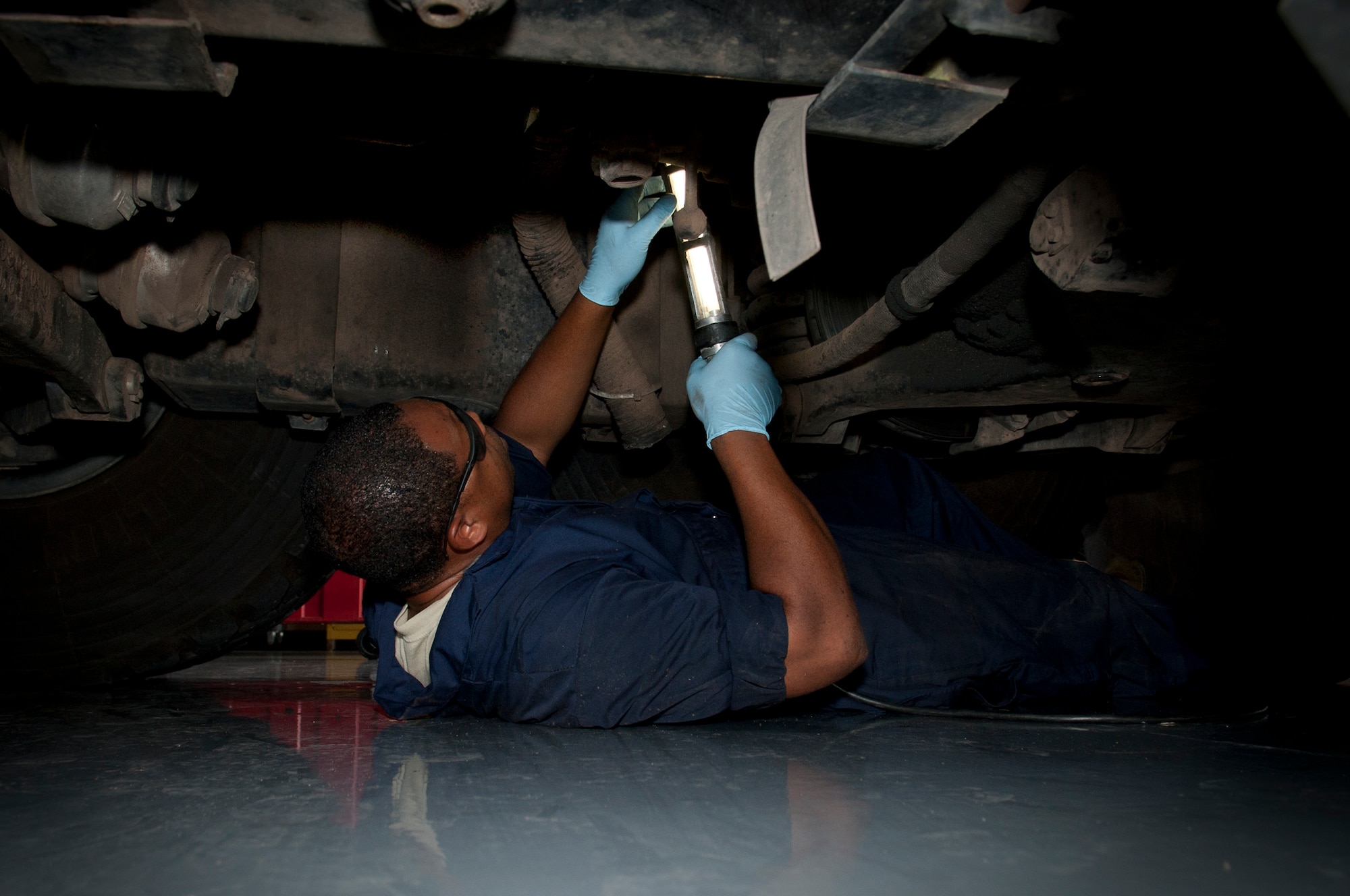 ALTUS AIR FORCE BASE, Okla. – Staff Sgt. Benjamin Jones, 97th Logistics Readiness Squadron fire truck and refueling maintenance shop mechanic, searches for an air line underneath a P-23 crash truck during a preventative maintenance inspection inside the vehicle maintenance shop, July 23. The shop’s mission is to maintain 44 refueling vehicles and fire trucks to ensure constant training and mission readiness. (U.S. Air Force photo by Senior Airman Dillon Davis/Released)