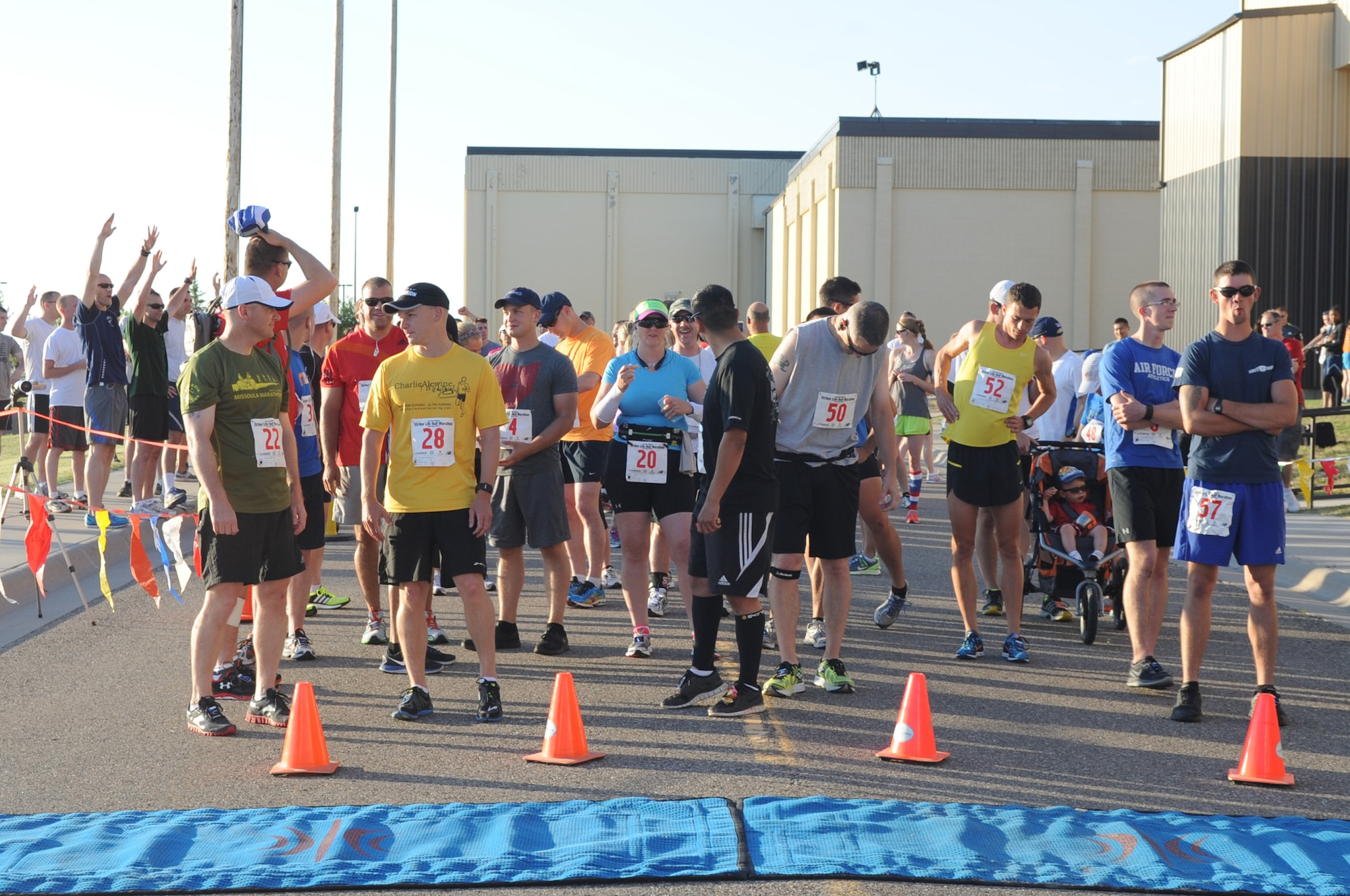 Team Malmstrom members warm up before participating in Malmstrom Air Force Base’s Second Annual Striker Life Half Marathon hosted at the Fitness Center on July 20. Attendees also had the opportunity to participate in several other events including a group half marathon relay, squadron 5K dash and a children’s fun run. (U.S. Air Force photo/Airman 1st Class Collin Schmidt)