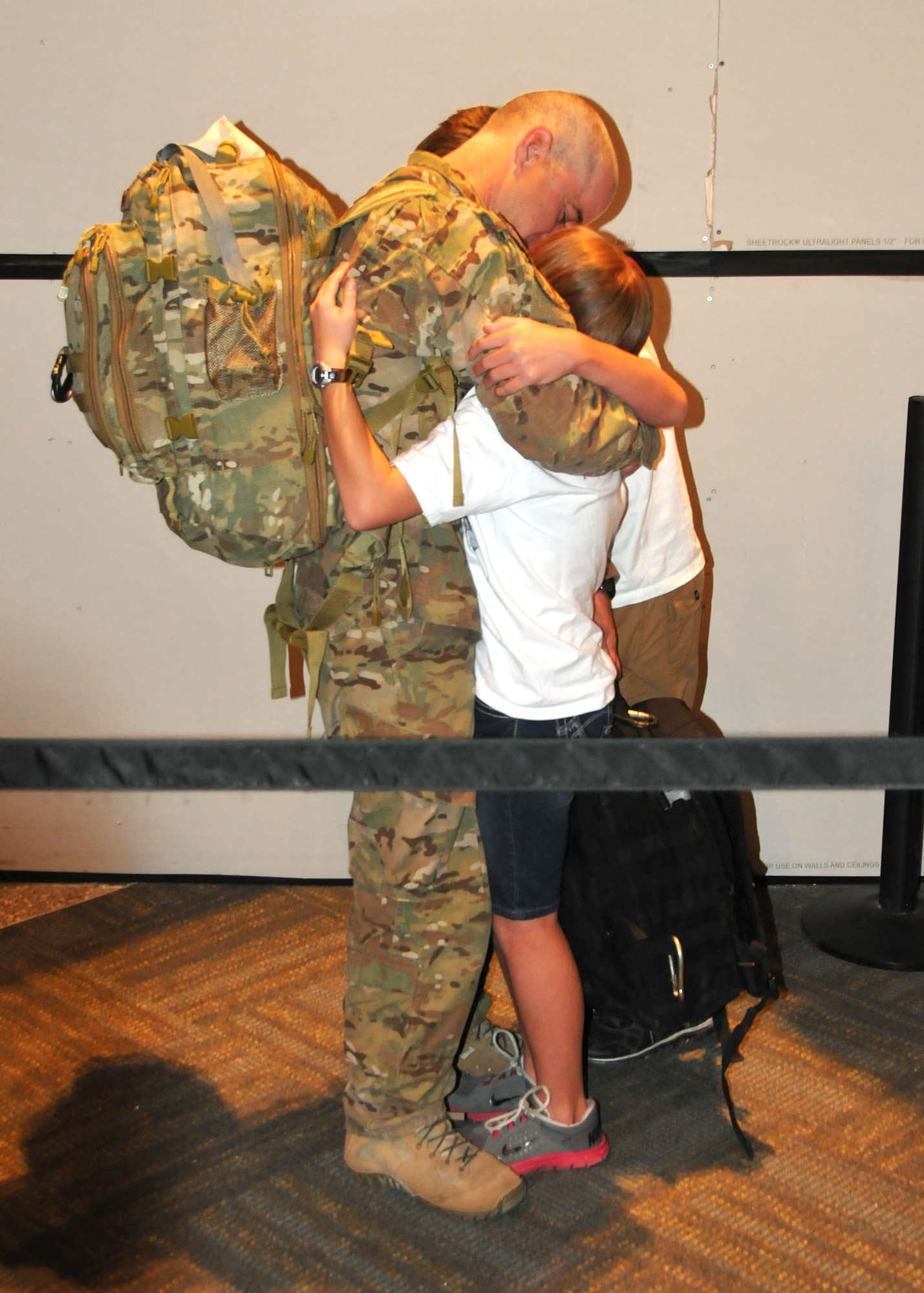 Senior Master Sgt. Kurt Trowbridge, 120th Security Forces Squadron member, is greeted and hugged by family members at the Great Falls International Airport on July 16. He had just returned to Great Falls after completing a six-month overseas deployment in support of Operation Enduring Freedom. (U.S. Air Force photo/Senior Master Sgt. Eric Peterson)
 
