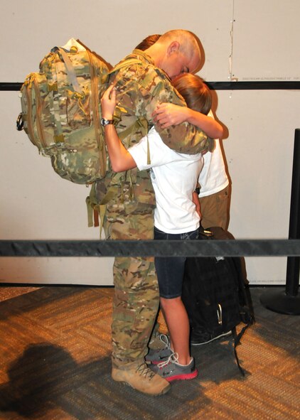 Senior Master Sgt. Kurt Trowbridge, 120th Security Forces Squadron member, is greeted and hugged by family members at the Great Falls International Airport on July 16. He had just returned to Great Falls after completing a six-month overseas deployment in support of Operation Enduring Freedom. (U.S. Air Force photo/Senior Master Sgt. Eric Peterson)
 
