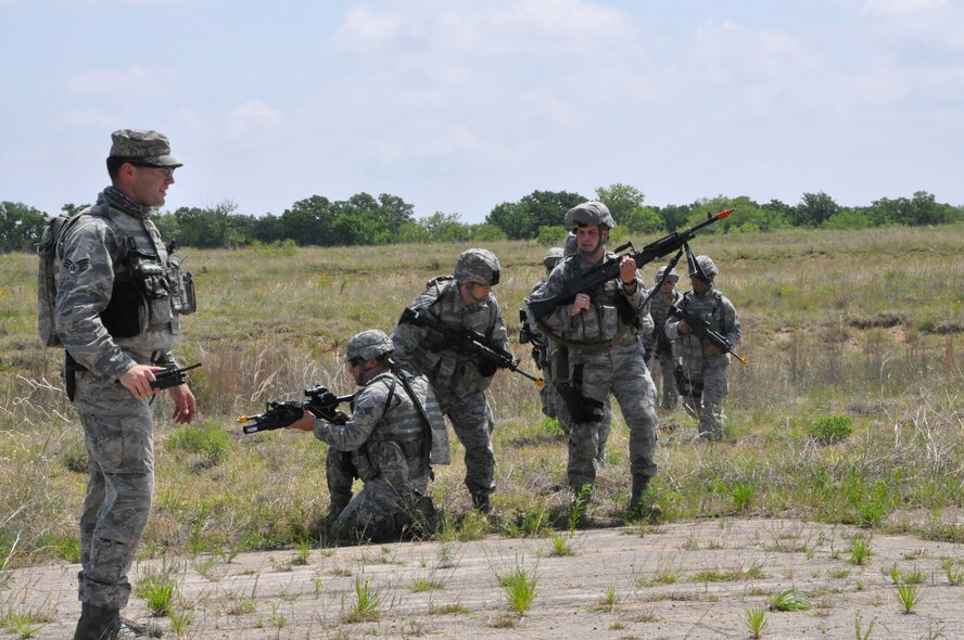Security forces personnel practice clearing a road before crossing, while an instructor watches technique during sustainment training at Fort Wolters, Mineral Wells, Texas May 2013. This type of training occurs every three years for security forces and includes class lectures and hands-on training. Participants include Airmen from around the nation who are new to the field and those who have years of experience. The training was conducted by 610th Security Forces Squadron personnel from Navail Air Station Fort Worth Joint Reserve Base, Texas (U.S. Air Force photo by Senior Airman Melissa Harvey)