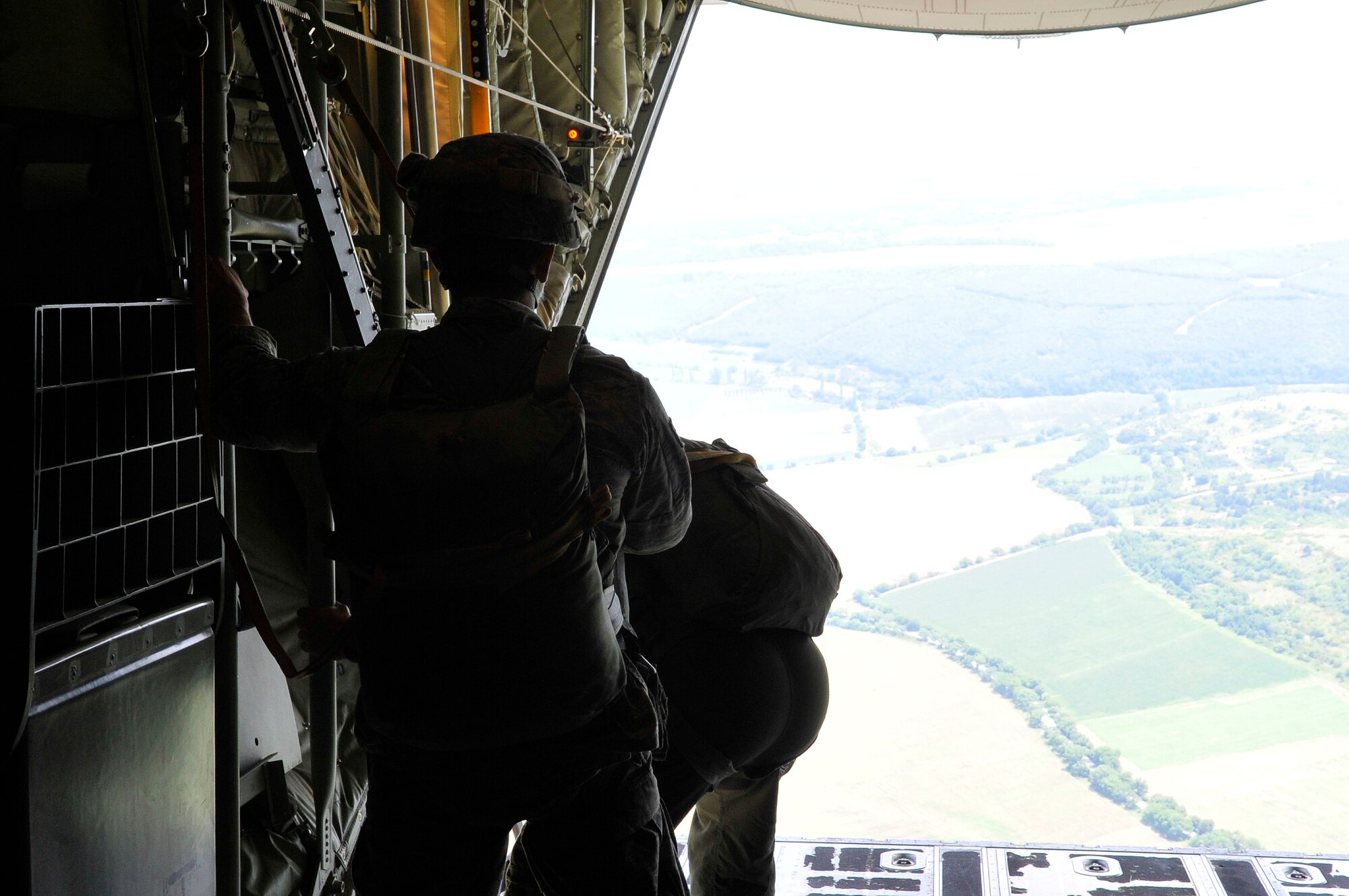 Two U.S. jumpmasters perform an inspection prior to a paratrooper drop a during flying training deployment, July 18, 2013, Plovdiv, Bulgaria. Jumpmasters are responsible for the safety of the paratroopers on their aircraft and ensuring they are dropped on the correct drop zone. (U.S. Air Force photo/Airman 1st Class Trevor Rhynes)