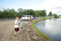 Children attending the Joint Base San Antonio-Randolph Youth Programs fishing camp practice casting skills July 17 at a pond near the Randolph Oaks Golf Course. (U.S. Air Force photo by Melissa Peterson)