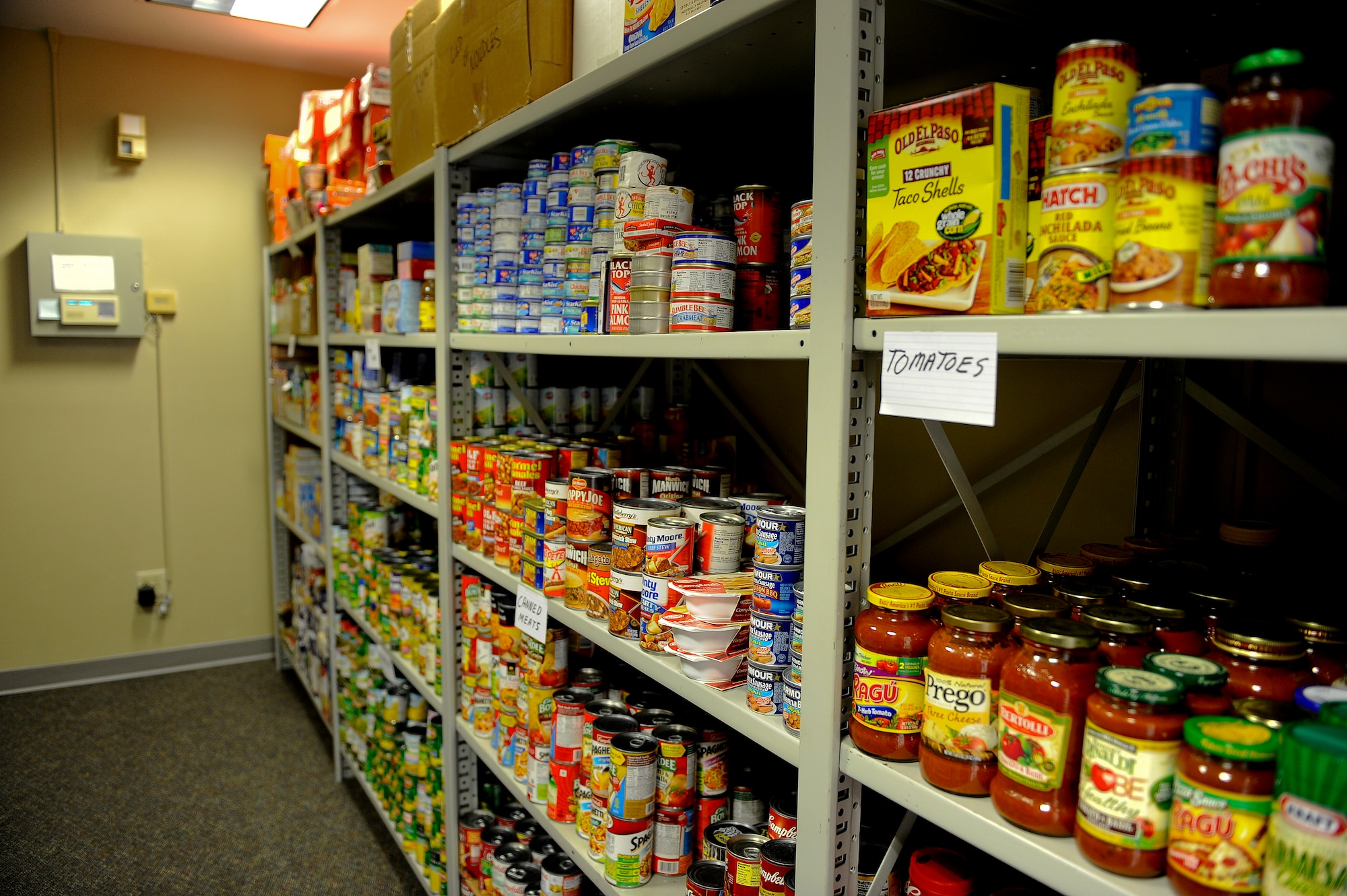 More than 3,000 pounds of non-perishable food sits on the shelves of the base food pantry located in the same building as the Airman’s Attic on Hurlburt Field, Fla., July 24, 2013. Due to sequestration and civilian furloughs, the food pantry recently opened its doors to civilian personnel. (U.S. Air Force photo by Airman 1st Class Jeffrey Parkinson)