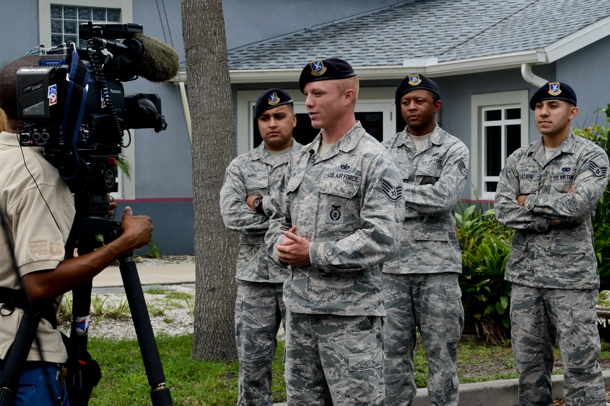 Staff Sgt. Shannon Hutto, 6th Security Forces Squadron military working dog lead trainer, talks to civilian media about the 6th SFS MWD volunteer efforts, July 19, 2013 at the Society for Prevention of Cruelty of Animals Tampa Bay in St. Petersburg, Fla. The 6th SFS members used their unique set of skills to train the SPCA Tampa Bay’s dogs basic commands. (U.S. Air Force photo by Senior Airman Melissa Paradise/Released/cropped for point of interest)