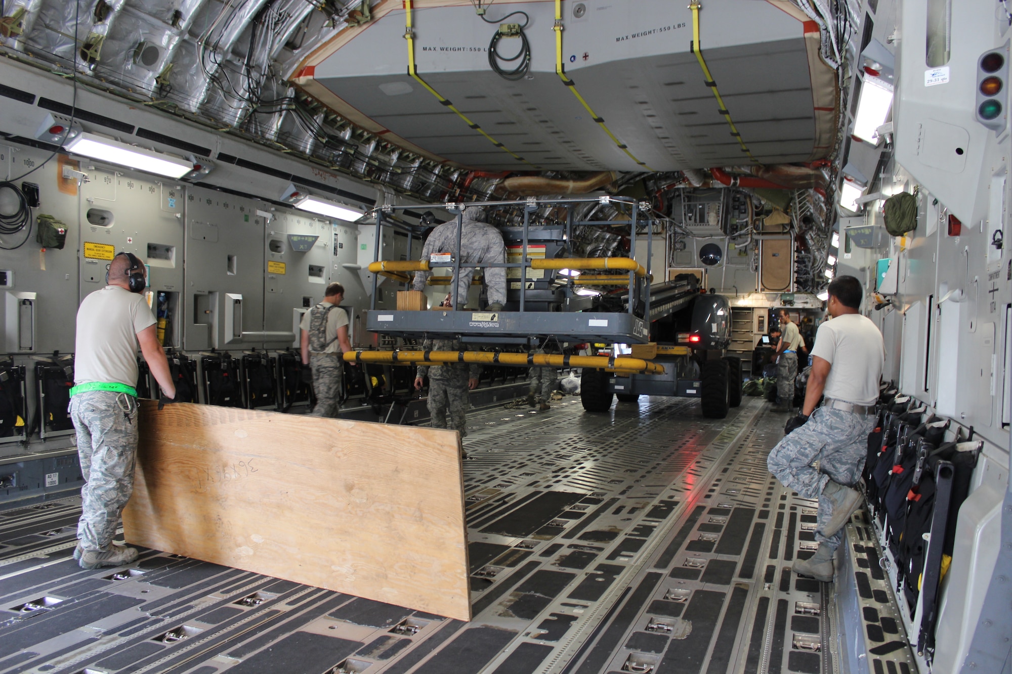 621st Contingency Response Wing Airmen load cargo onto a C-17 Globemaster III at the Ascension Auxiliary Airfield Ramp at Ascension Island in the Southern Atlantic Ocean, June 28, 2013.The normally tranquil island transformed into a major military aircraft hub during the month-long operation moving equipment and passengers to and from Africa in preparation for President Barack Obama’s official state visit to the African continent. (U.S. Air Force photo by Capt. David Bredesen)