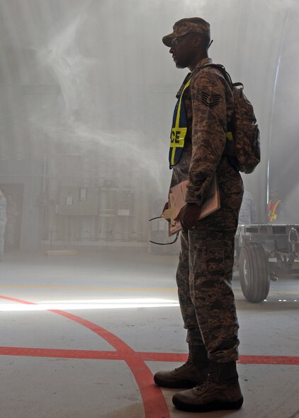 Tech. Sgt. Dettorree Tobias, 39th Security Forces Squadron NCO in charge of standards and evaluations, oversees a room sweep during an exercise July 24, 2013, at Incirlik Air Base, Turkey. Standards and evaluation teams watch for areas of improvement to provide feedback on the actions of emergency responders. (U.S. Air Force photo by Senior Airman Chase Hedrick/Released)