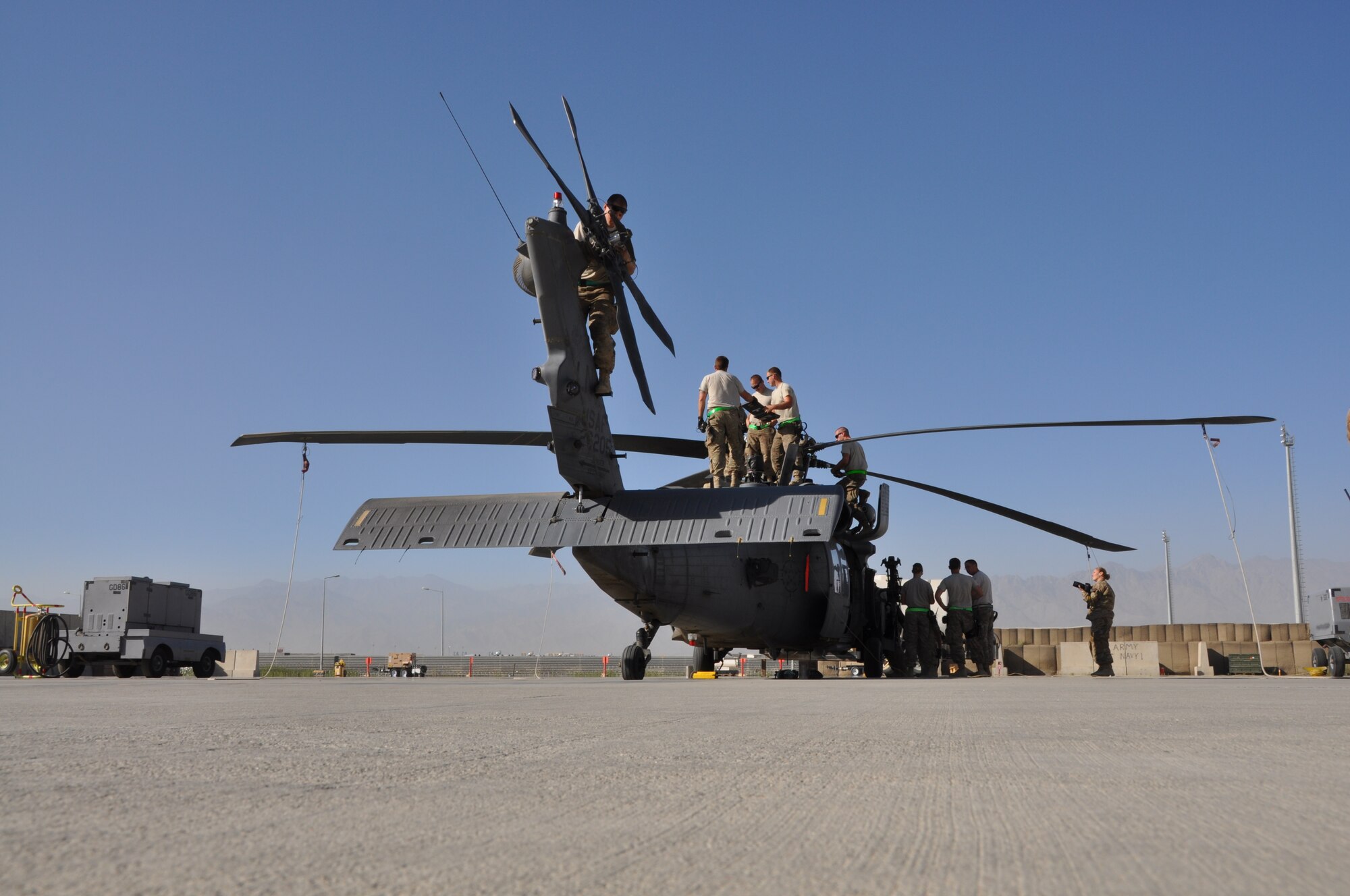 Service members from the 455th Expeditionary Maintenance Squadron conduct a 50-hour preventative maintenance inspection on aircraft 89-6205, an HH-60G Pave Hawk helicopter assigned to the 56th Expeditionary Helicopter Maintenance Unit at Bagram Airfield, Afghanistan, July 24, 2013. The Airmen, are deployed from the 748th Aircraft Maintenance Squadron at Royal Air Force Lakenheath, England. (U.S. Air Force photo/Tech. Sgt. Rob Hazelett)