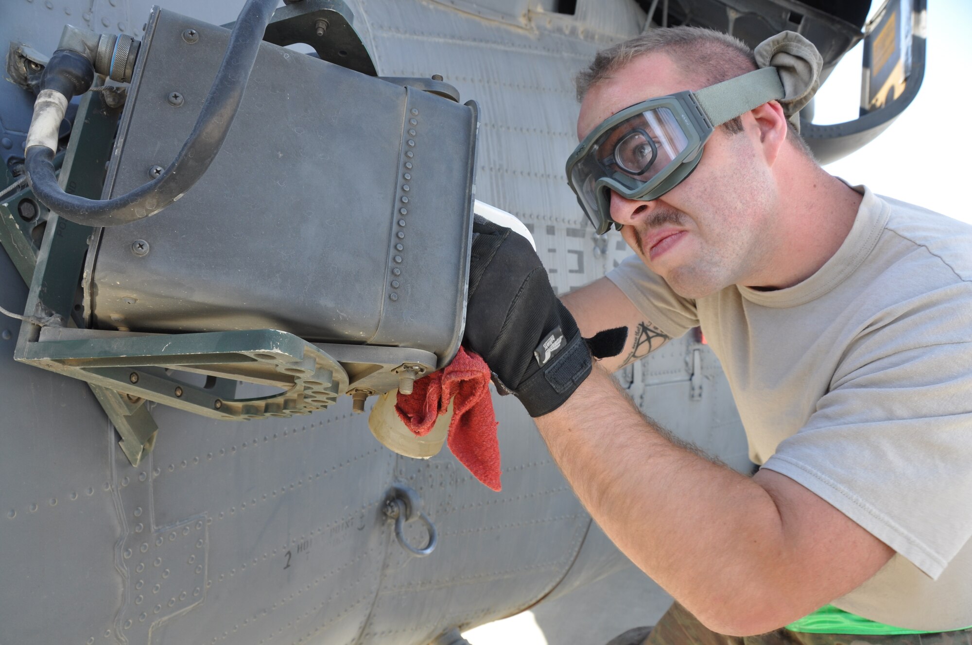 Staff Sgt. Kolby Kell, 455th Expeditionary Maintenance Squadron electronic warfare craftsmen, helps conduct a 50-hour preventative maintenance inspection on aircraft 89-6205, an HH-60G Pave Hawk helicopter assigned to the 56th Expeditionary Helicopter Maintenance Unit at Bagram Airfield, Afghanistan, July 24, 2013. The helo achieved the coveted black-letter initial exceptional release July 23, 2013, for the first time in the unit since 2005. After the ER was signed, the HH-60 launched as part of a mission attributed to saving two lives later the same day. Aircraft 89-6205 happens to be the same aircraft that attained the status for the unit eight years ago. (U.S. Air Force photo/Tech. Sgt. Rob Hazelett)