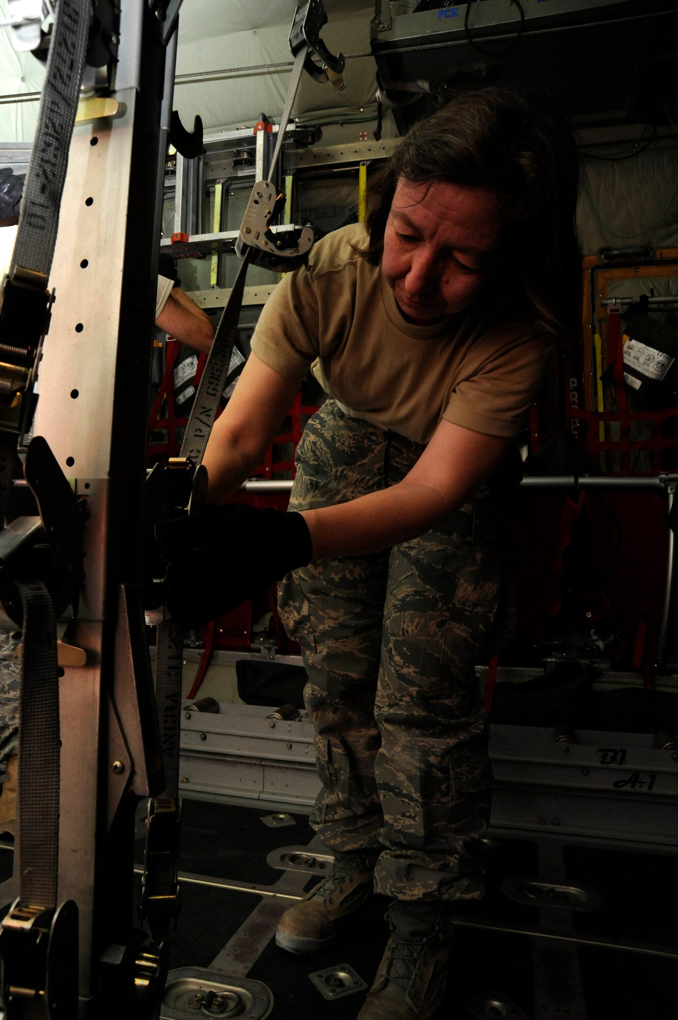Master Sgt. Judy Johnson performs a “spot and dot” on a stanchion while prepping a C-130 Hercules for an aeromedical evacuation mission at the 379th Air Expeditionary Wing in Southwest Asia, July 24, 2013. A spot and dot is a technique used to secure j-hooks into stanchions at the proper height. Johnson is the 379th Expeditionary Aeromedical Evacuation Squadron logistics NCO in charge deployed from Will Rogers Air National Guard Base, Okla. (U.S. Air Force photo/Senior Airman Bahja J. Jones) 