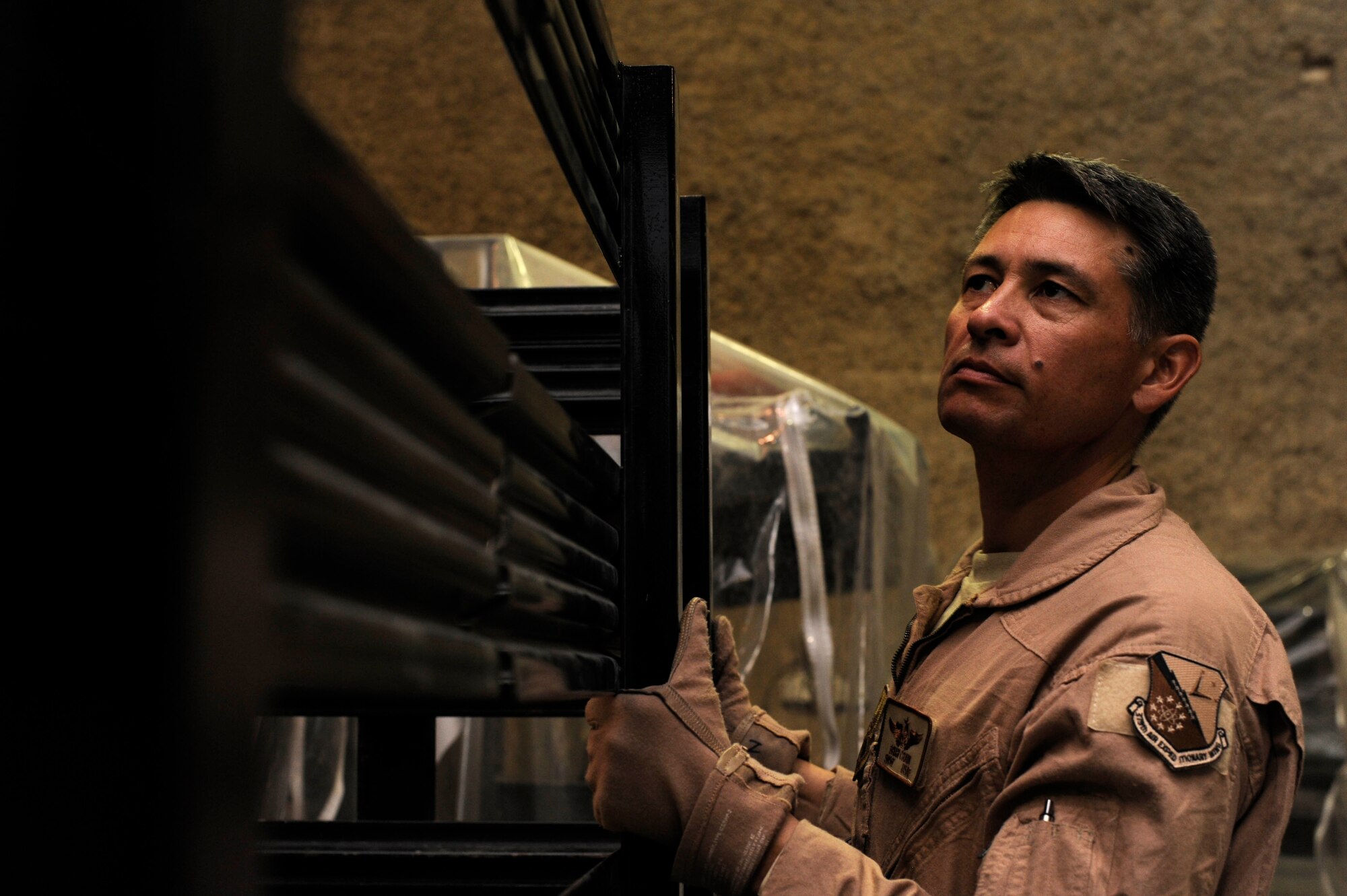 Senior Master Sgt. Brian Crain places guardrails onto a truck filled with medical equipment in preparation for an aeromedical evacuation mission. Crain is the 379th Expeditionary Aeromedical Evacuation Squadron superintendent deployed from Will Rogers Air National Guard Base, Okla. (U.S. Air Force photo/Senior Airman Bahja J. Jones) 