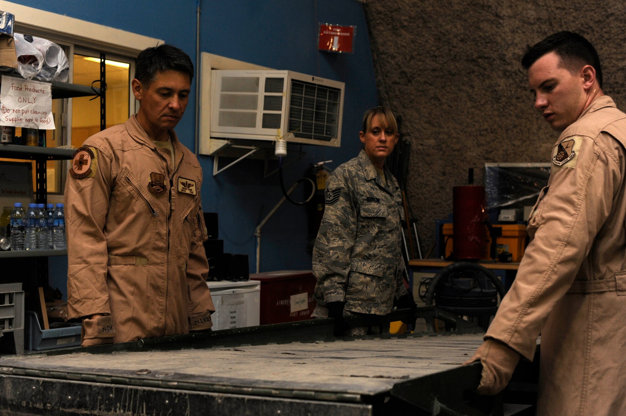 A team of 379th Expeditionary Aeromedical Evacuation Squadron aeromedical evacuation technicians move a ramp used to load medical supplies onto a truck for an upcoming mission at the 379th Air Expeditionary Wing in Southwest Asia, July 24, 2013. Off-duty AE technicians come in and assist the Aeromedical Evacuation Operations Team here as they coordinate missions to ensure the planes are in the air on-time. (U.S. Air Force photo/Senior Airman Bahja J. Jones) 