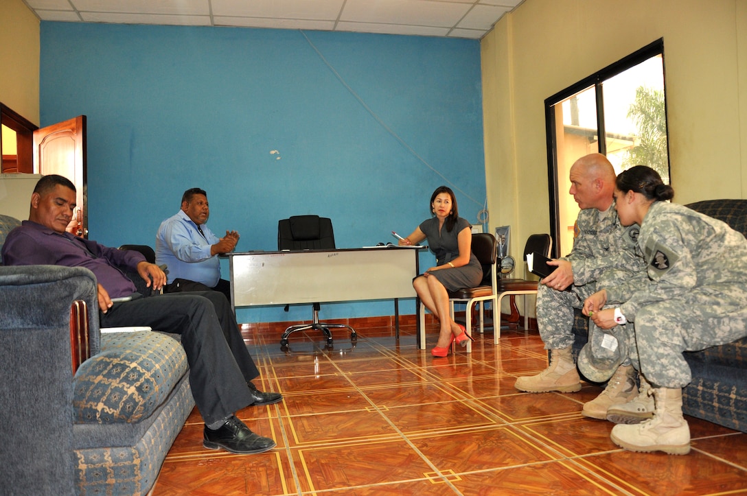 Col. Thomas D. Boccardi, Joint Task Force-Bravo commander, right, speaks with Juan de Dios Avila, Ajuterique deputy mayor, left, among other city leaders as West Point Cadet Beatriz Martorell, center, translates, at the Ajuterique municipality July 19, 2013. Col. Boccardi met with local leaders to inform them although JTF-Bravo has a new commander the mission to be honored guest and partners is still the same.(Photo released by Air Force Staff Sgt. Jarrod R. Chavana)  