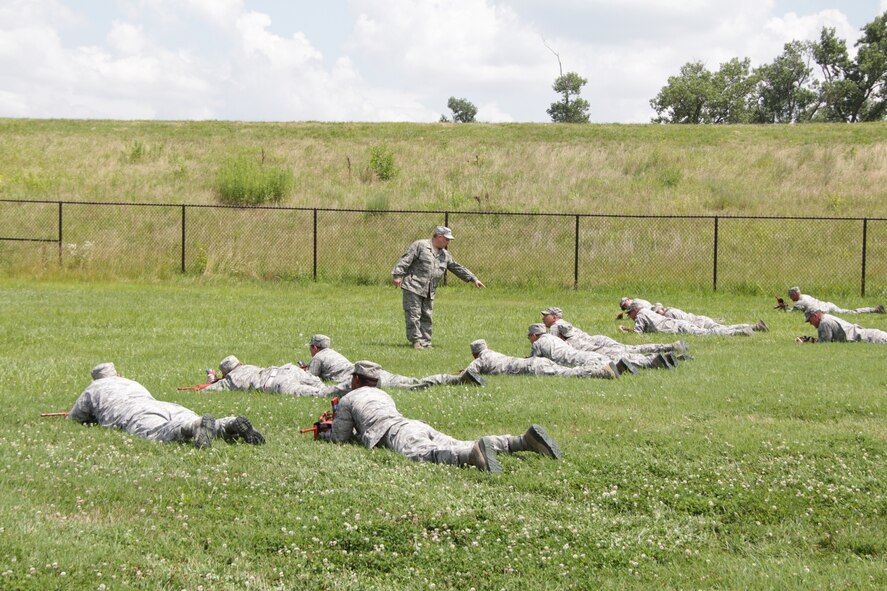 Tech Sgt. Craig Stratmann instructs 932nd Airlift Wing Civil Engineers Squadron members in a weapons formation during the July unit training assembly.  This training is done so that they can protect their equipment while forward deployed. (U.S. Air Force photo/Staff Sgt. Meiko Schill)