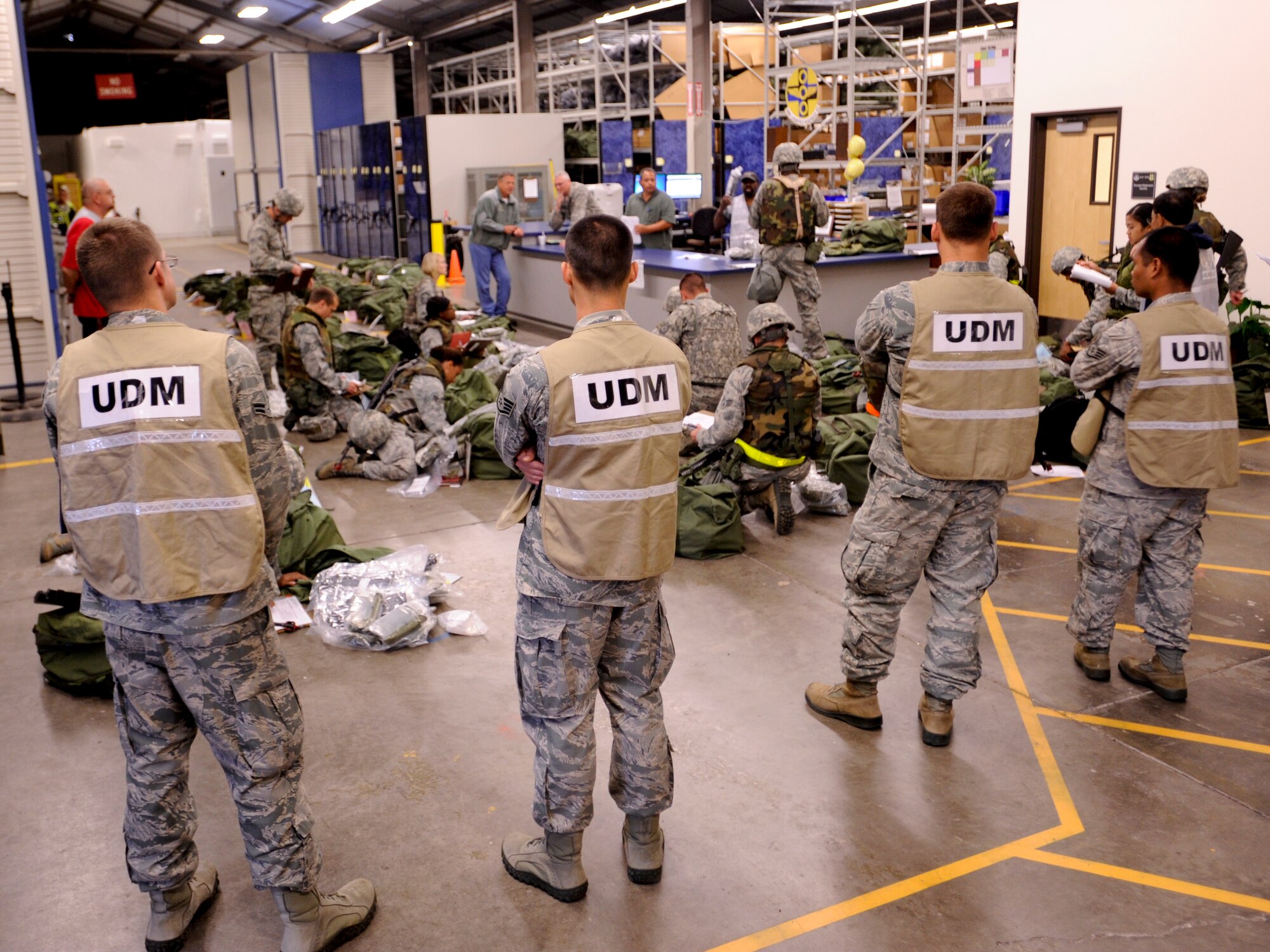 VANDENBERG AIR FORCE BASE, Calif. – Unit Deployment Managers stand by to assist the deploying Airmen during an exercise here Thursday, July 25, 2013. The exercise was held as part of a Consolidated Unit Inspection, a biannual inspection used to measure the base’s discipline, readiness and war fighting capability through exercises, inspection and evaluations. (U.S. Air Force photo/Airman Yvonne Morales)