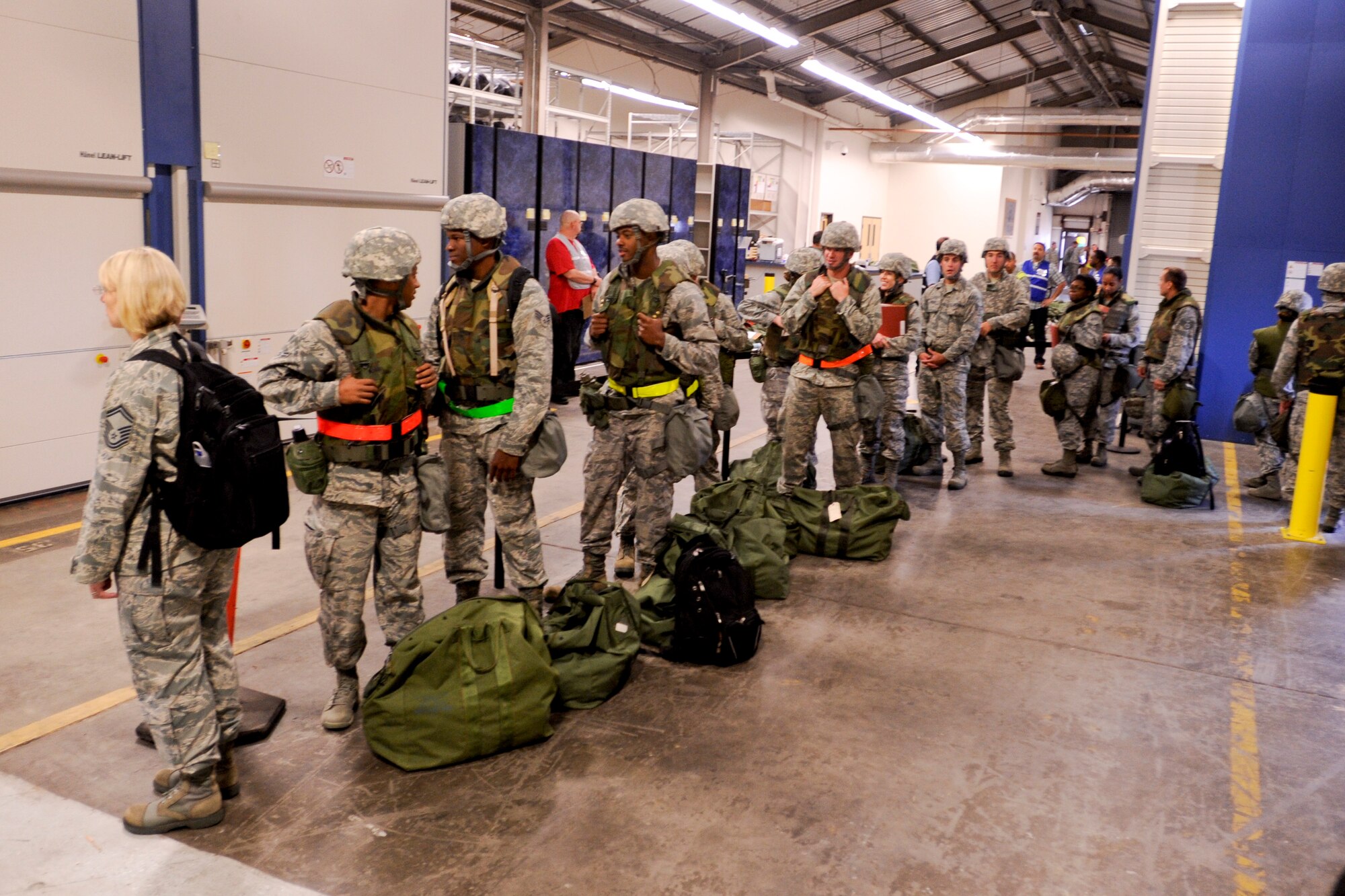 VANDENBERG AIR FORCE BASE, Calif. – Team V chalk 1 members wait in line to receive their weapon during an exercise here Thursday, July 25, 2013. The exercise was held as part of a Consolidated Unit Inspection, a biannual inspection used to measure the base’s discipline, readiness and war fighting capability through exercises, inspection and evaluations. (U.S. Air Force photo/Airman Yvonne Morales)