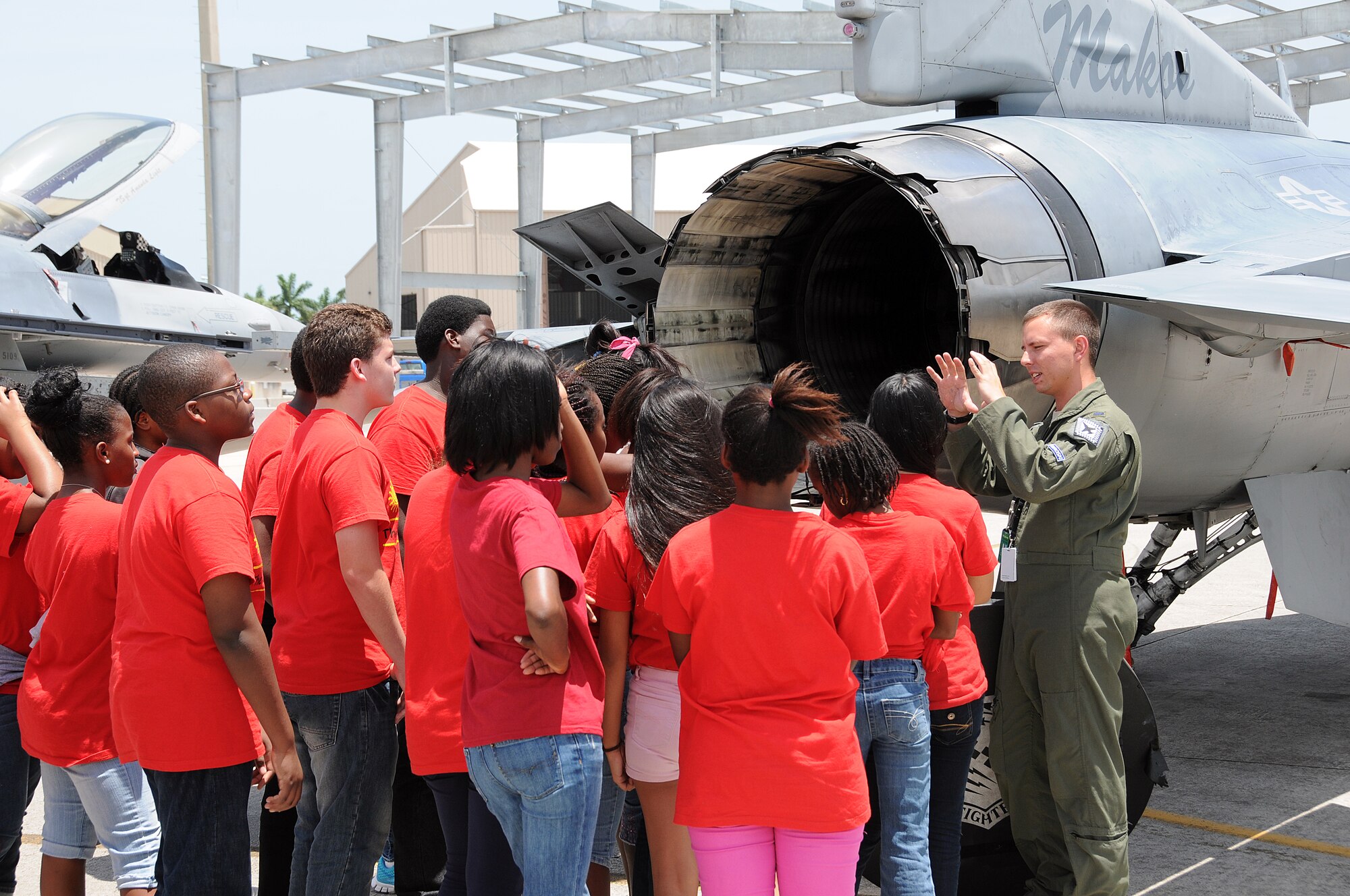 First lieutenant Shane Vaughn an F-16 pilot from the 93rd Fighter Squadron speaks to members of Take Stock in Children Miami during a base tour at Homestead Air Reserve Base on July 25. Take Stock in Children was established in 1995 as a non-profit organization in Florida that provides a unique opportunity for deserving low-income youth/students, many from minority families, to escape the cycle of poverty through education. They offer students college scholarships, caring volunteer mentors and hope for a better life.  Their comprehensive services start in middle school, continue through high school and include their transition into college. (U.S. Air Force photo/Tim Norton)
