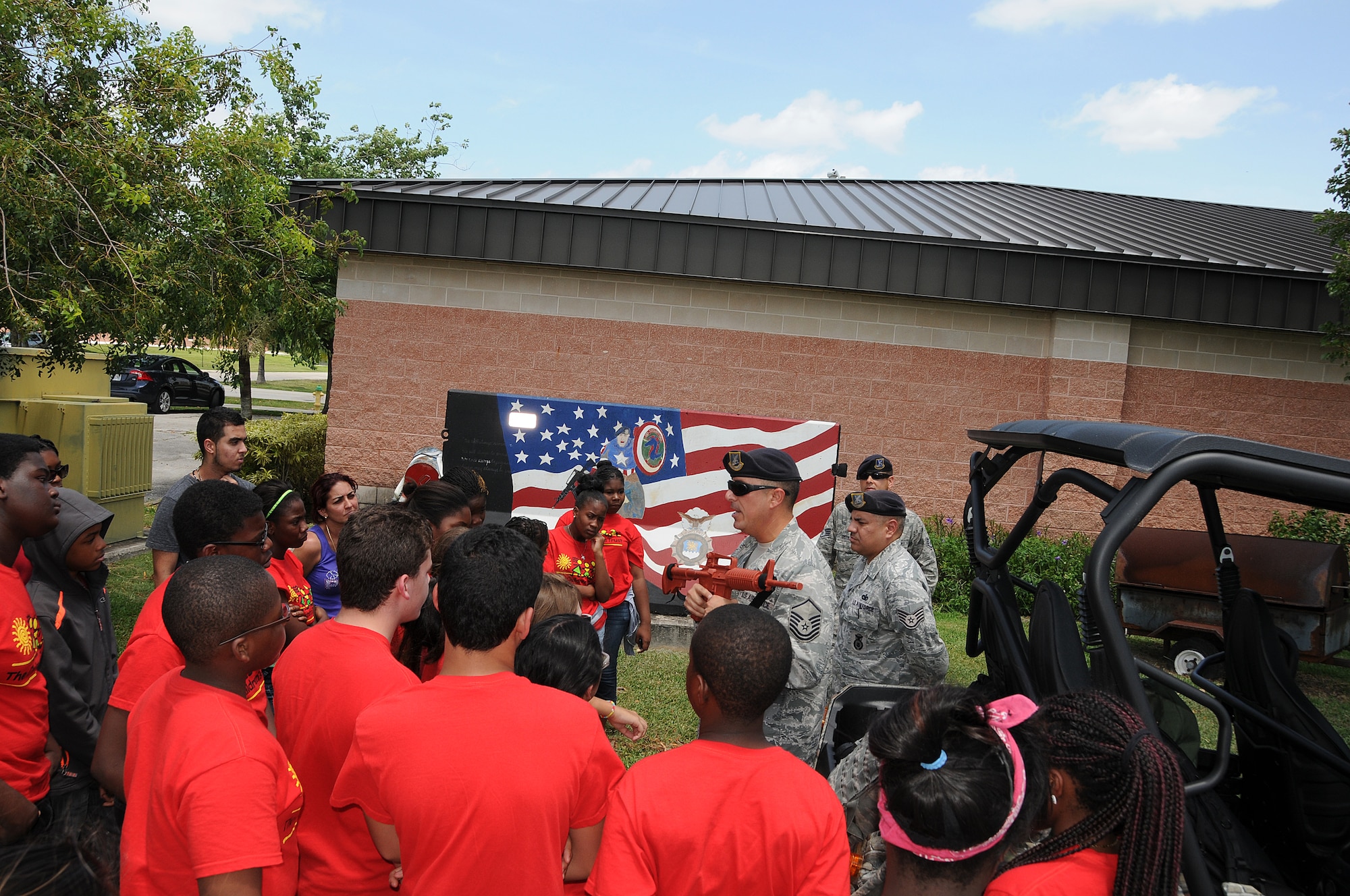 Master Sgt. John Frank and members from the 482nd Security Forces Squadron talk to members of Take Stock in Children Miami during a base tour at Homestead Air Reserve Base on July 25. Take Stock in Children was established in 1995 as a non-profit organization in Florida that provides a unique opportunity for deserving low-income youth/students, many from minority families, to escape the cycle of poverty through education.They offer students college scholarships, caring volunteer mentors and hope for a better life.  Their comprehensive services start in middle school, continue through high school and include their transition into college. (U.S. Air Force photo/Tim Norton)