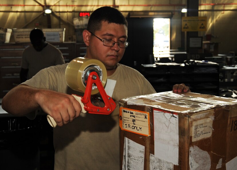 Senior Airman Juan Flores, 2nd Logistics Readiness Squadron shipment distribution center apprentice, tapes a box on Barksdale Air Force Base, La., July 25, 2013. The shipment distribution center primarily deals with cargo belonging to both active duty and reserve units. (U.S. Air Force photo/Senior Airman Sean Martin)