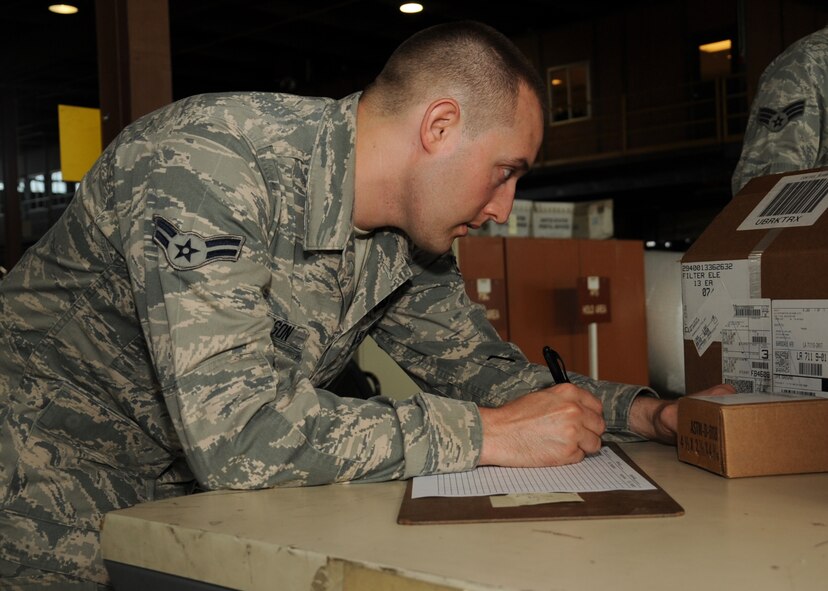 Airman 1st Class Joseph Henderson, 2nd Logistics Readiness Squadron shipment distribution center apprentice, checks the label of a package on Barksdale Air Force Base, La., July 25, 2013. The shipment distribution center is responsible for receiving inbound shipments for the 2nd Bomb Wing and tenant units. (U.S. Air Force photo/Senior Airman Sean Martin)